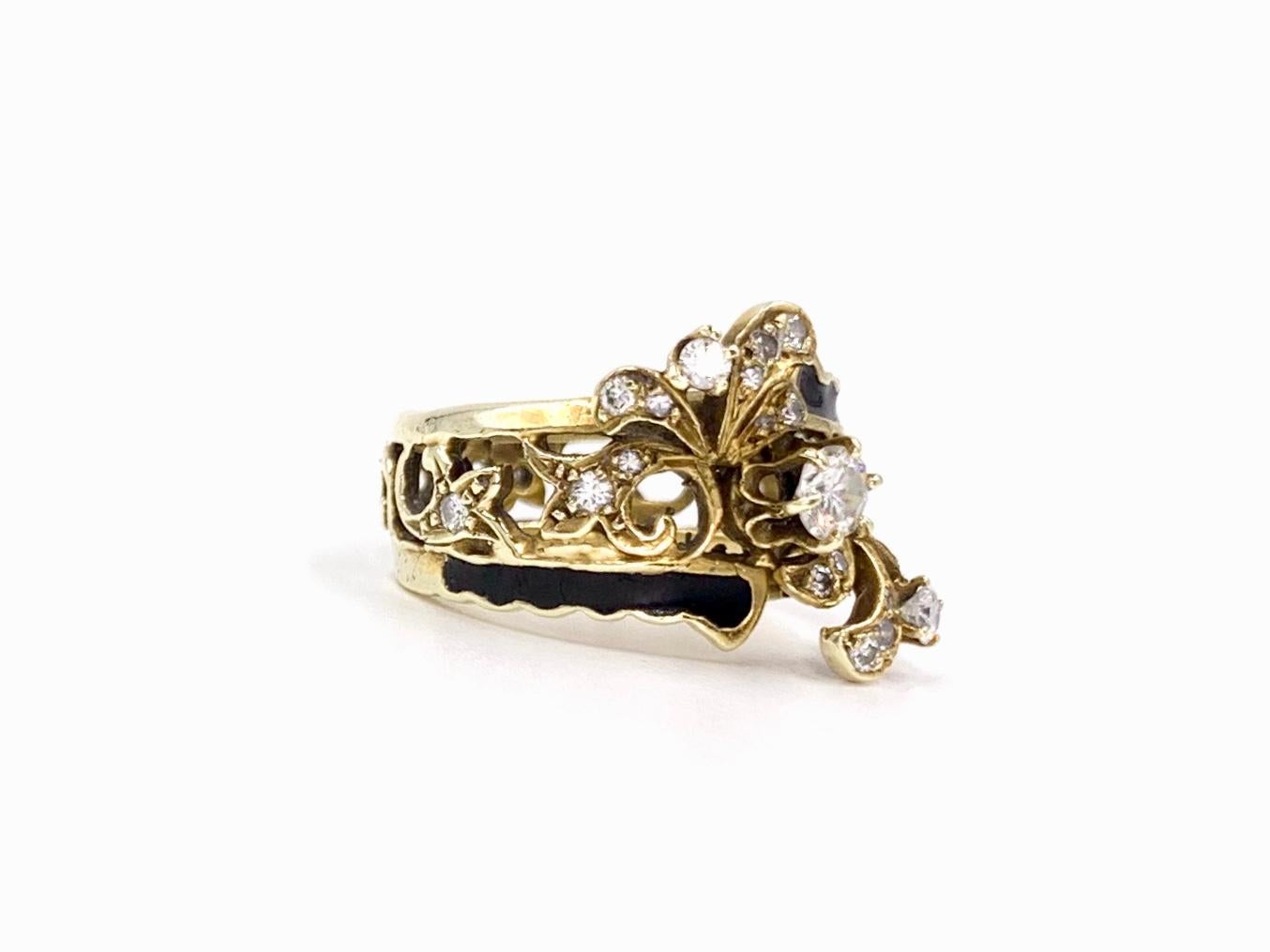An elegantly designed Victorian inspired 14 karat yellow gold filigree ring with incredible detail and design. The ring features a total of 26 round brilliant diamonds at approximately .60 carats total weight. Ring features hand painted black