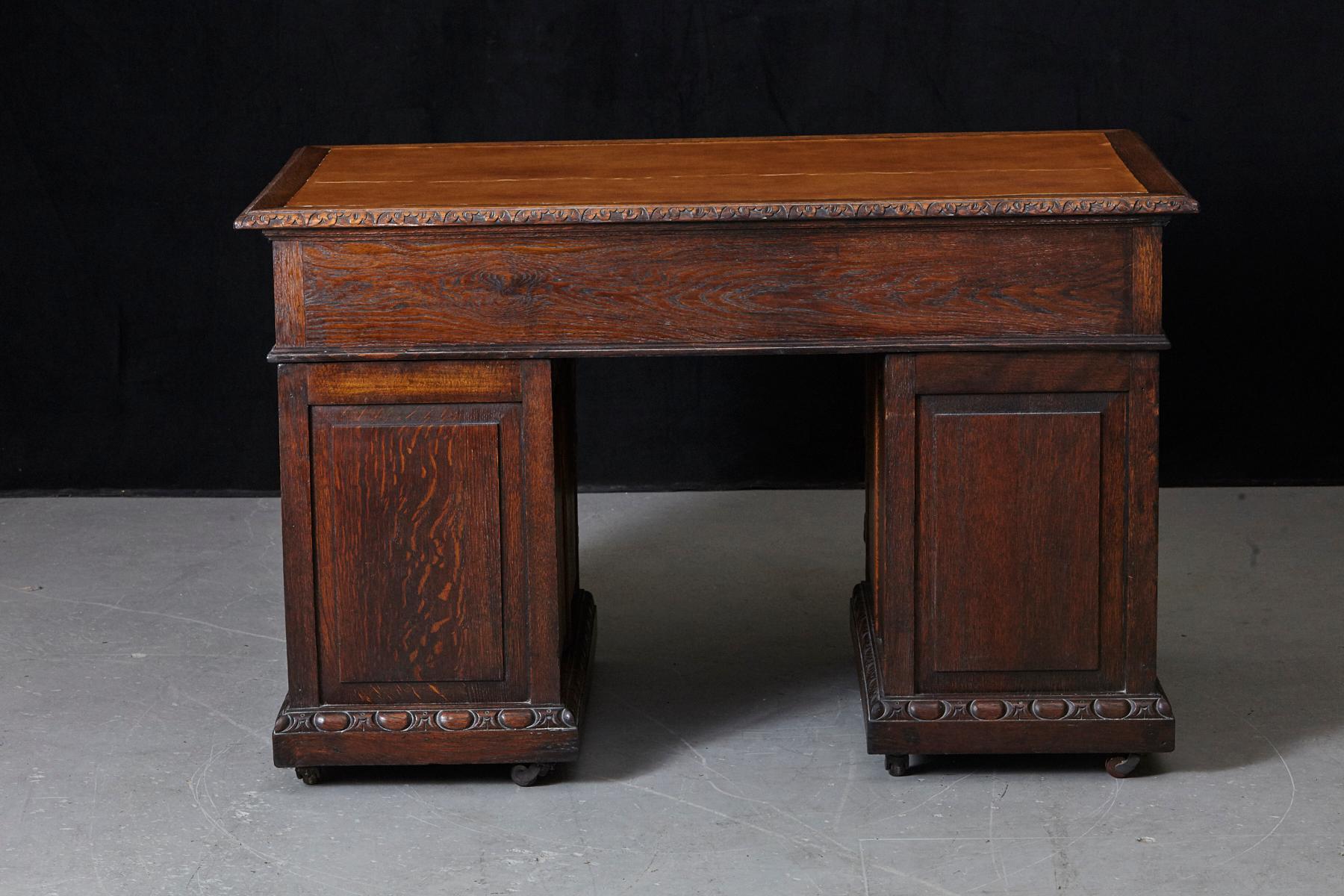 Leather Victorian Intricately Carved Oak Kneehole Desk with Lion Head Handles