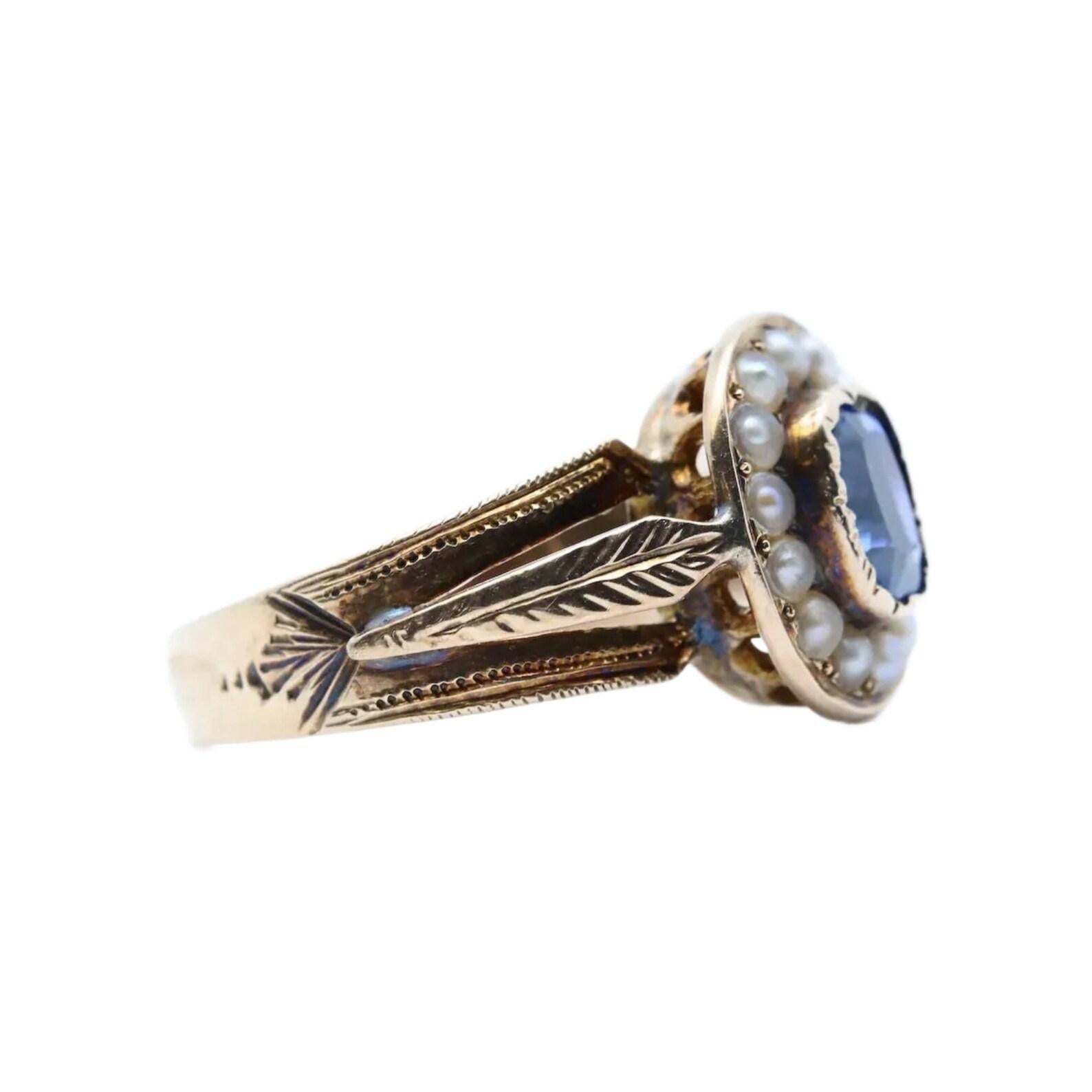 An early victorian period blue Iolite and natural split pearl ring in 14 karat yellow gold. Centered by a 1.00 carat vivid blue natural Iolite which often mistaken for blue sapphire. Surrounding the bezel set Iolite are 14 natural split pearls