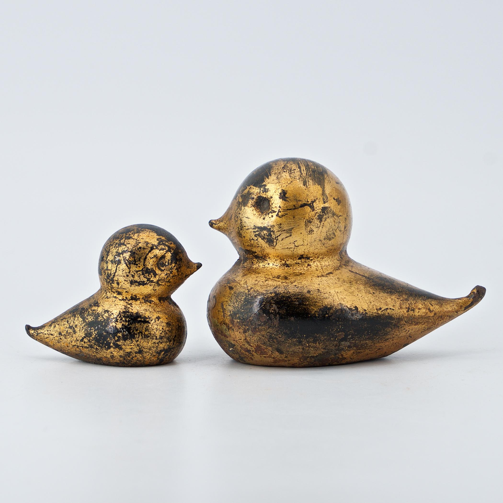 Rare pair of cast iron Kewpie birds; mother and child. Large one weighs approx. 2.5 lbs. and is 4 inches long, small one is about a third of that.