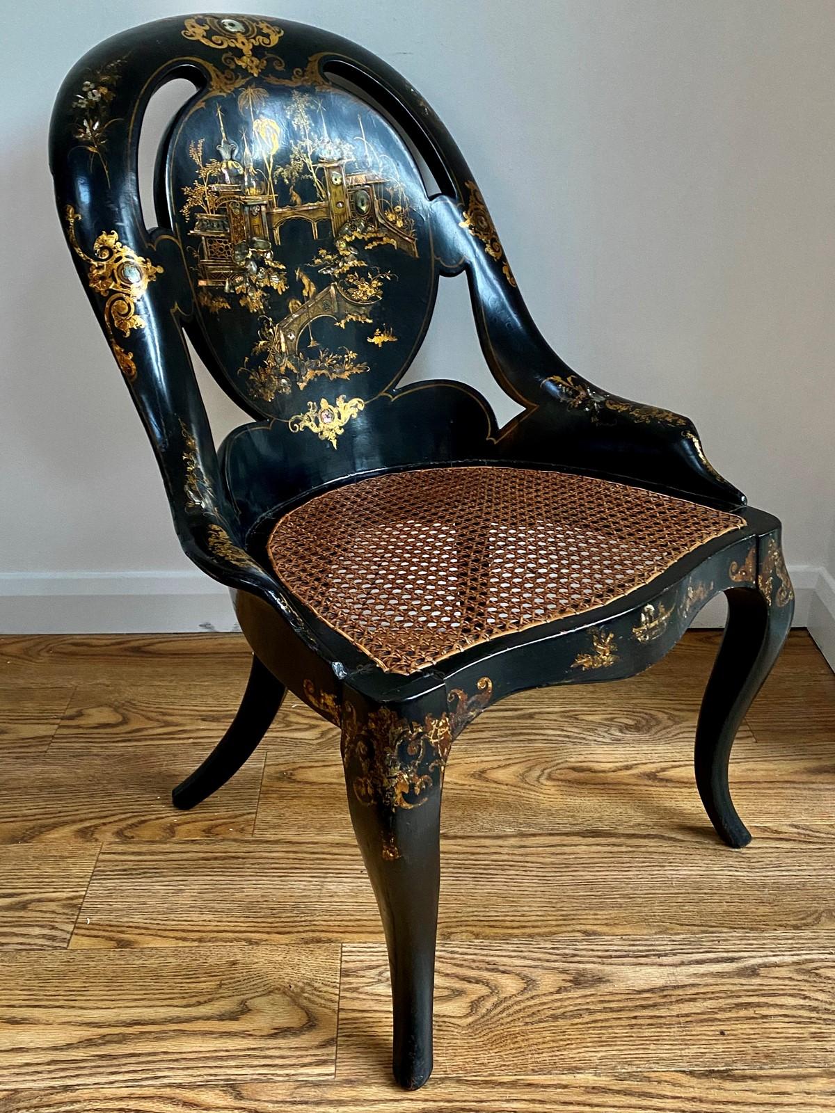 A good example of a Victorian Japanned and inlaid papier mâché caned slipper chair possibly Jennens and Bettridge The pierced slipper back of scalloped form is beautifully gilded and inlaid with mother of pearl. Decorated with oriental scenes of