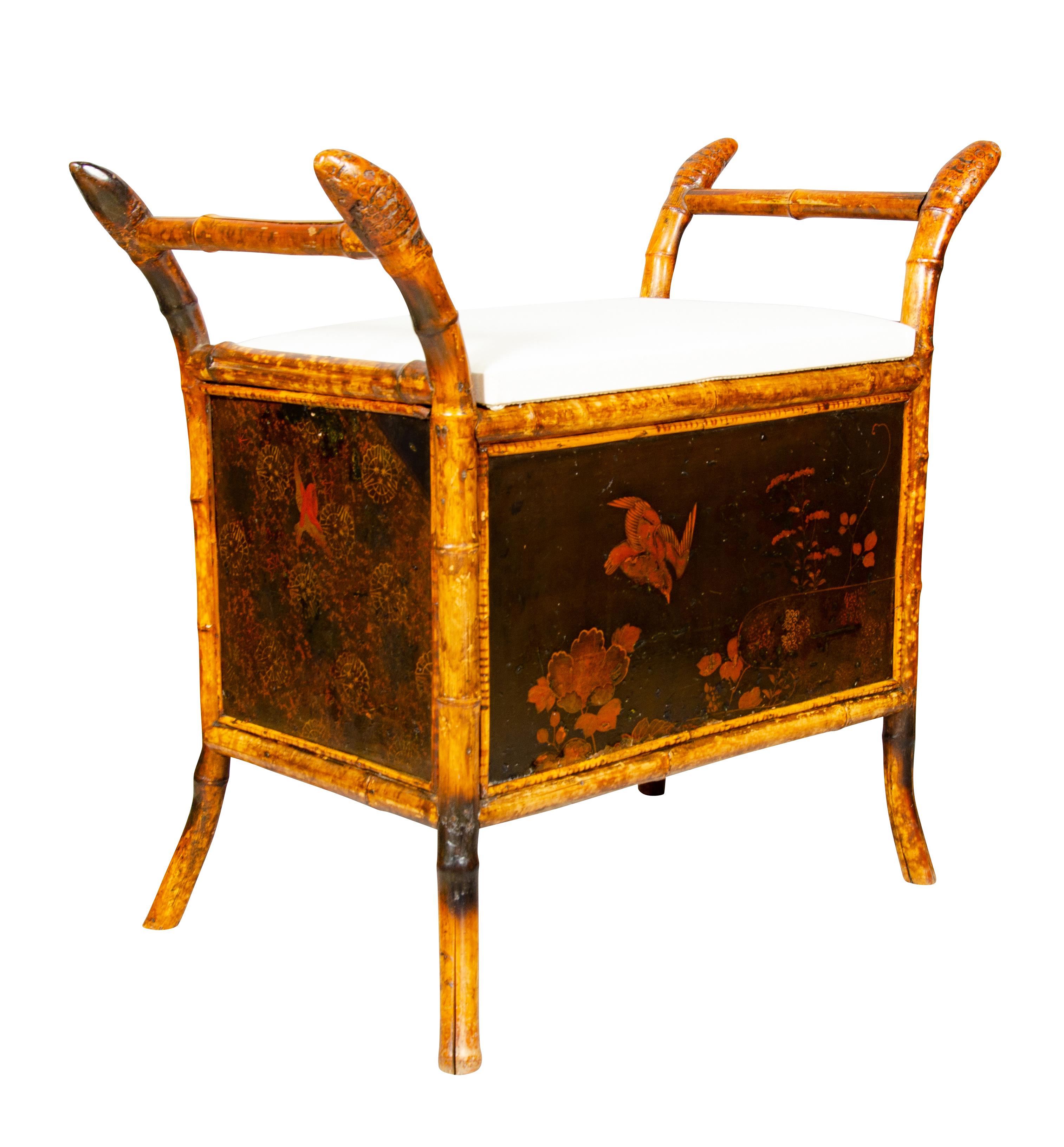 With rectangular new muslin upholstered hinged lid opening to an open slotted compartment. Scrolled arms. Chinoiserie decorated case section, bamboo legs. Provenance; Estate of interior designer William Hodgins, Boston Ma.