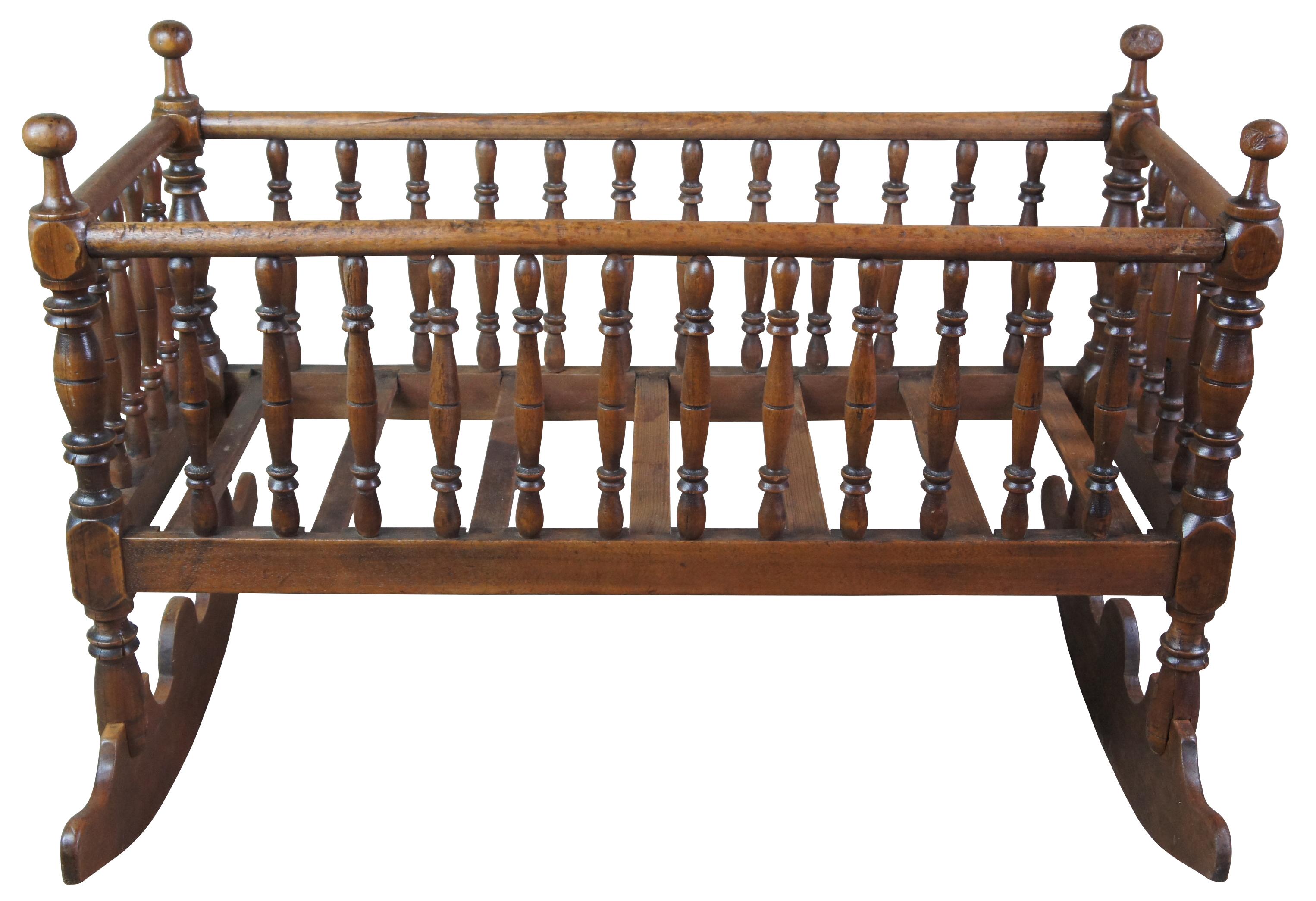 Antique hand turned spindle rocking cradle or bassinet. Made from walnut with a beautiful shape and form. 

29.5