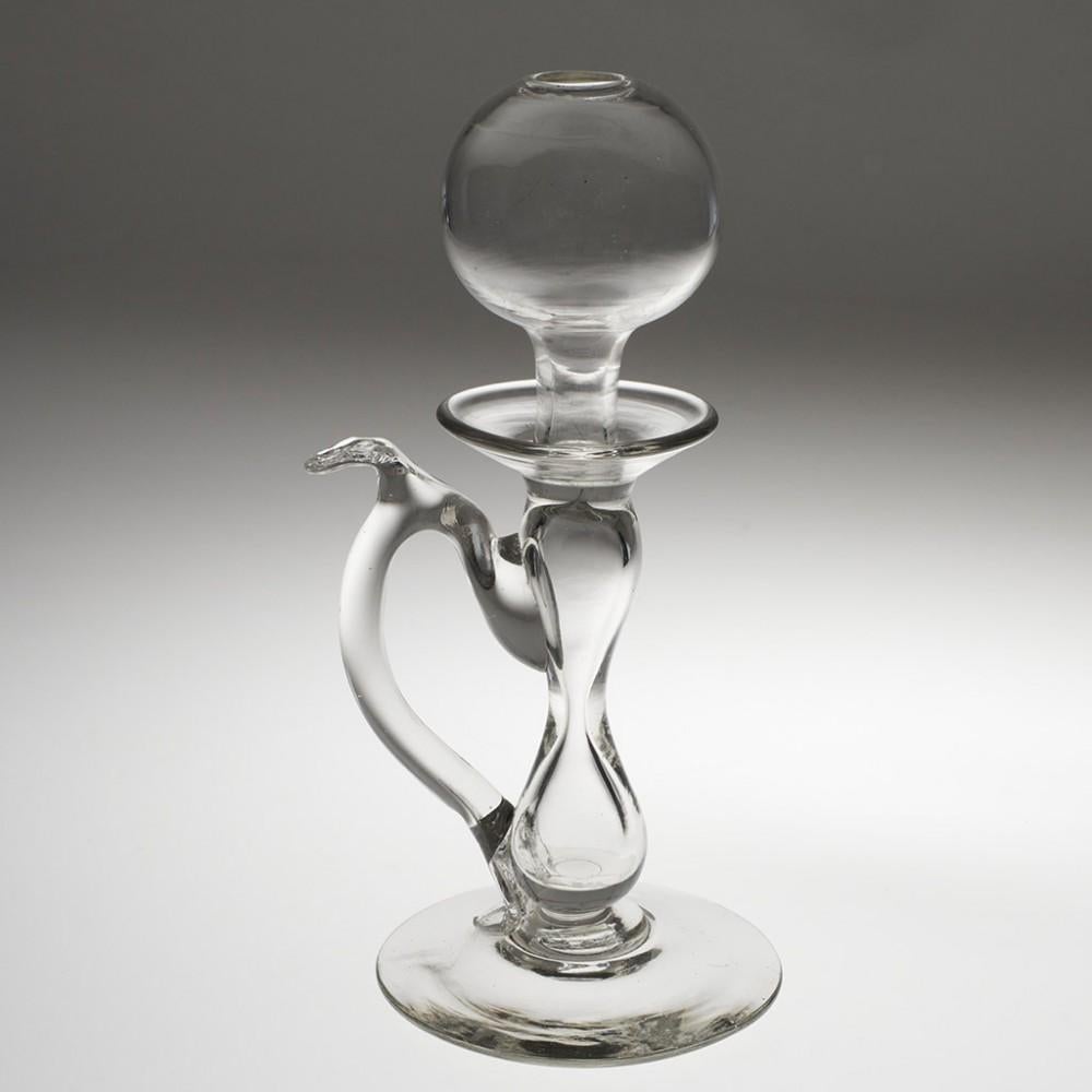 Heading : 19th century lacemaker's oil lamp
Date : c1870
Period : Victoria 
Origin : England
Colour : Clear
Bowl : Spherical oil reservoir bowl
Stem : Large hollow baluster and inverted baluster. Applied crimped handle with thumb rest
Base : Conical