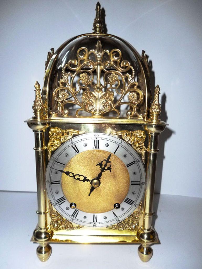 Victorian Lantern clock with beautifully pierced frets surmounted by a large bell with centre finial.
Silvered chapter ring with Roman numerals and finely matted centre.
The side doors with starburst decoration, eight day spring wound movement by