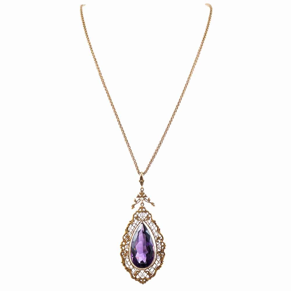 Natural pearls scattered artfully in Art Nouveau scroll work surrounding an exquisite show-stopping pear shaped amethyst. The beautiful hand made chain measures 22 inches in length and the pendant measures 3.5 inches from the top of the bail to the