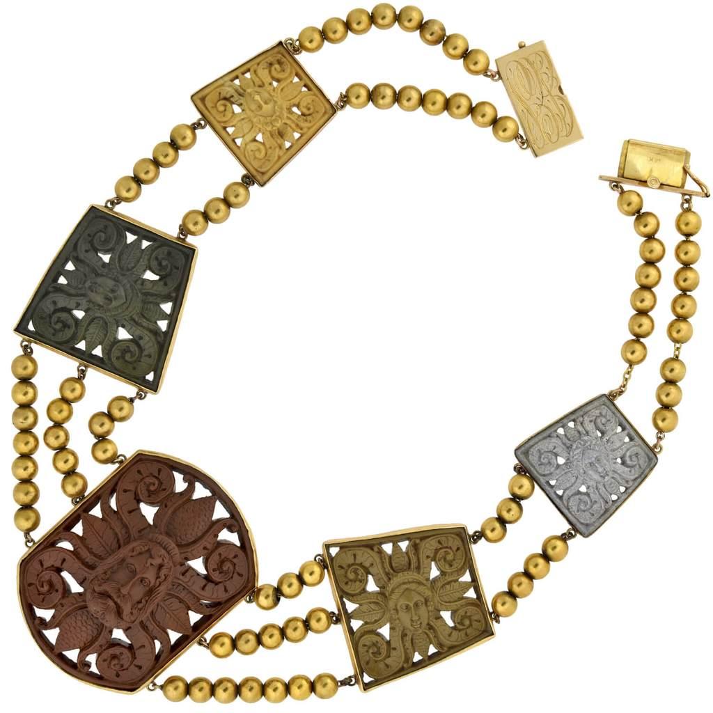 An absolutely incredible lava cameo necklace from the Victorian (ca1880s) era! Crafted in 14kt yellow gold, this fantastic piece features five large cameos carved from multi-colored pieces of lava. Each bezel set cameo is skillfully hand-carved to