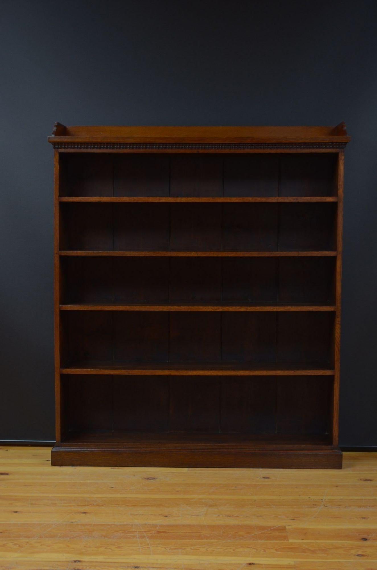 ST052 Victorian large solid oak country open bookcase having oversailing top fitted with upstand and moulded edge decoration to the under side of the top, with four shelves that are in a fixed position graduating in size. All standing on a plinth
