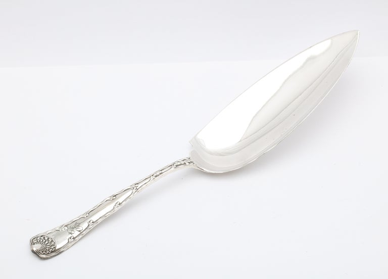 Large, sterling silver ice cream slicer/server. Tiffany and Co., New York, circa 1890s, Wave Edge pattern. Measures 12 inches long x 2 1/2 inches wide (at widest point) x 2 1/2 inches high (at highest point) when lying flat. Has a lovely, script,