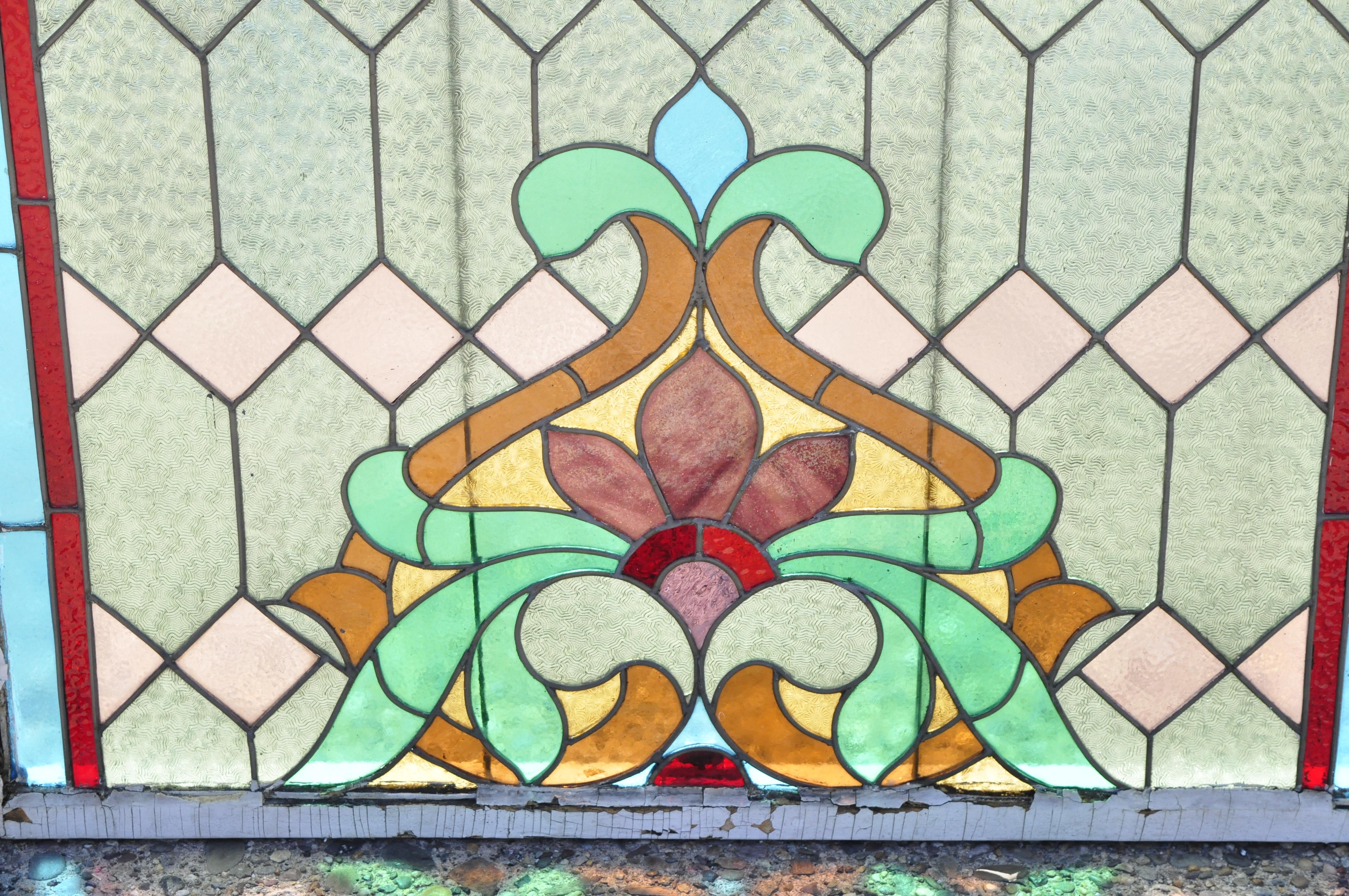 Antique Victorian leaded stained glass blue green pink orange Fleur de Lis 34 x 40 Window. Item features blue and red stained glass border, multi color 