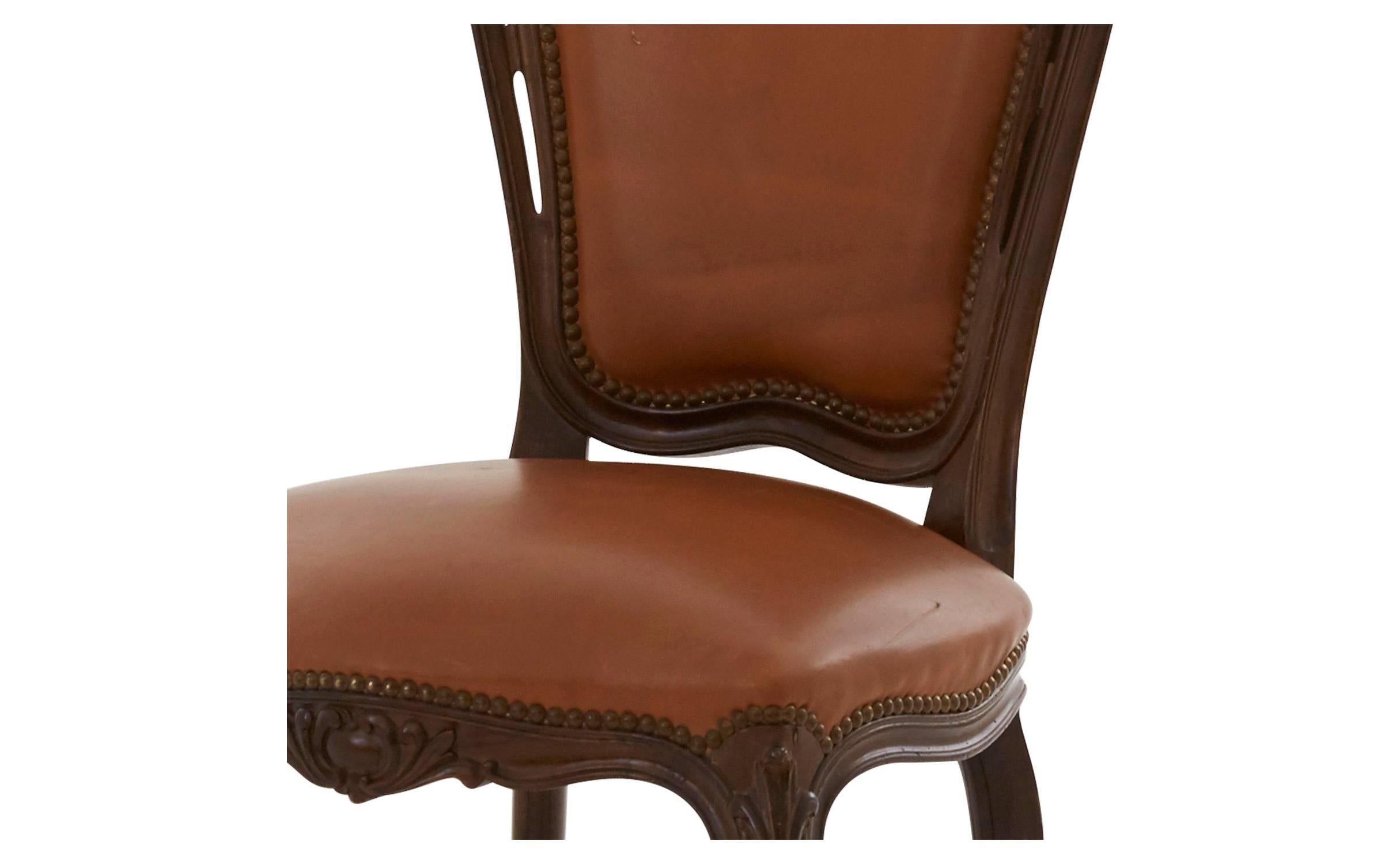 • Original caramel leather upholstery
• Ornate wood frame with antique nailhead trim, 
• 20th century, 
• Spain

Dimensions:
•overall: 17' D x 20.5' W x 40.5' H 
•seat height: 18' H.
