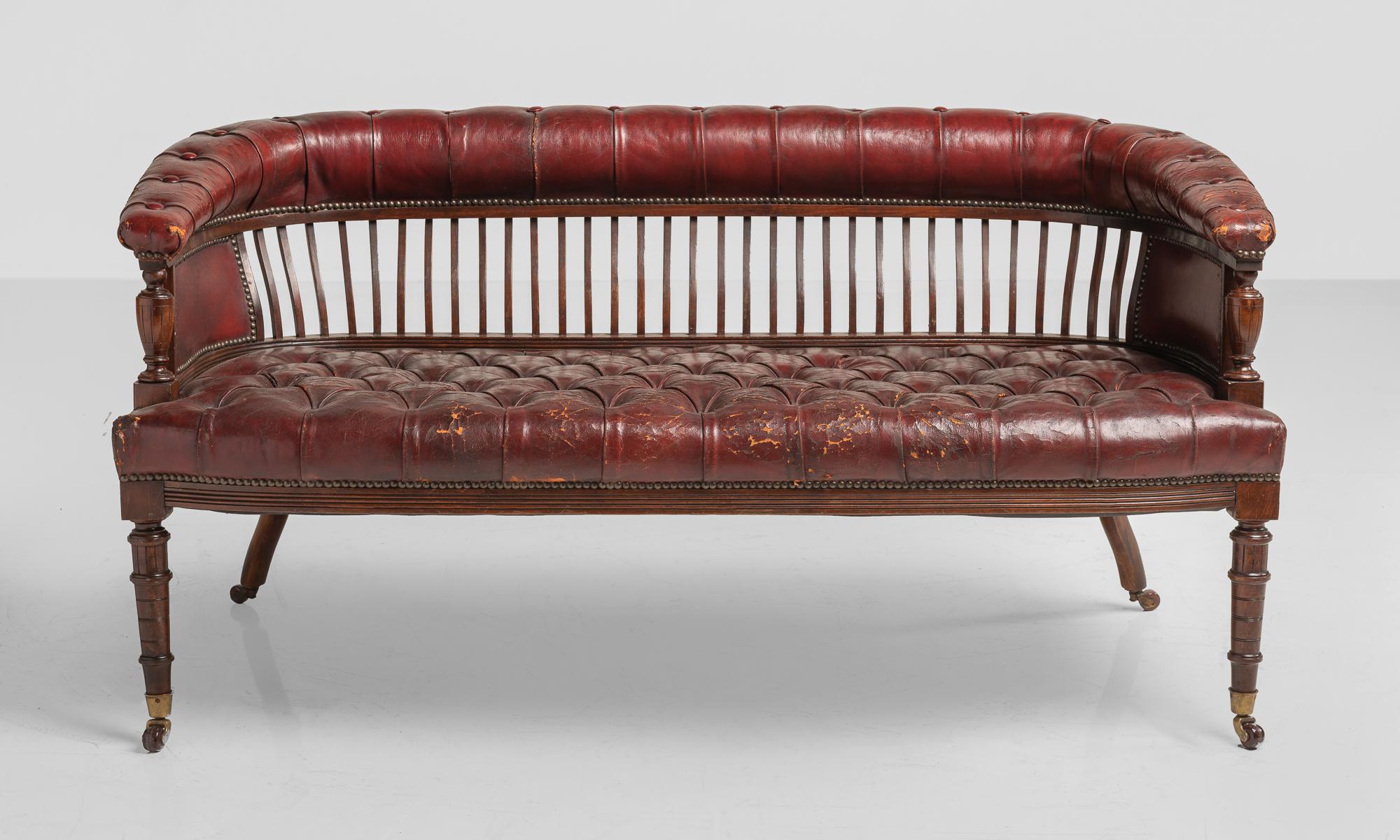 Victorian Leather & Walnut Sofa, England, circa 1900

Buttoned leather seat and backrest with slatted walnut back. On handsome turned legs with original brass castors.

Measures: 54