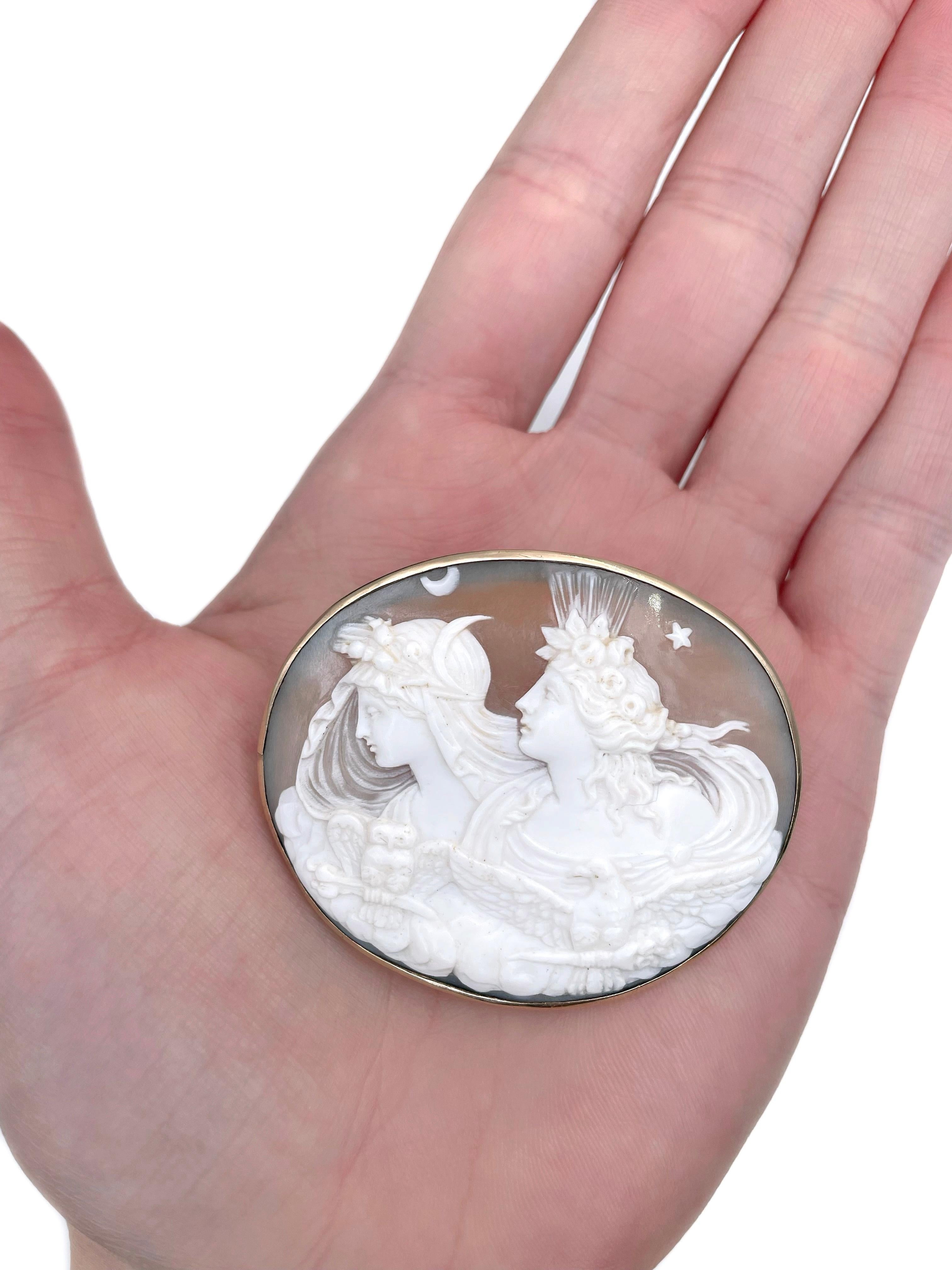 This is a Victorian oval pin brooch - the allegory of the Day and Night. Circa 1870. 

It features a shell cameo depicting Eos (Greek goddess of Dawn) and Nyx (Greek goddess of night).

The frame with a needle is crafted in base metal and is gold