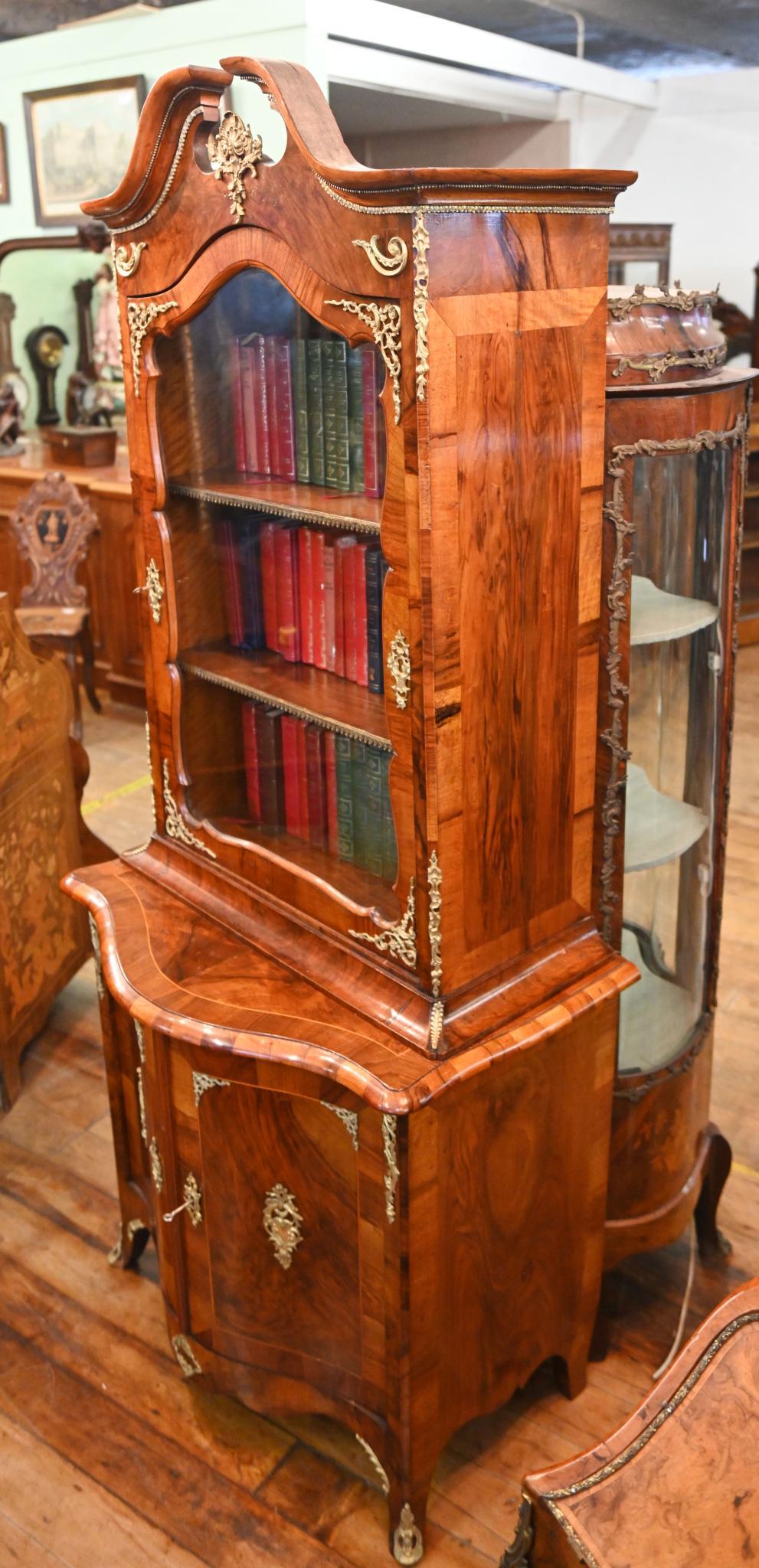 Victorian burr walnut library bookcase
Crossbanded doors and ormulo fittings
Lovely patina to the burr walnut, this piece of furniture reeks of quality
Comes with key and working locks
Top half features the glass fronted cabinet section