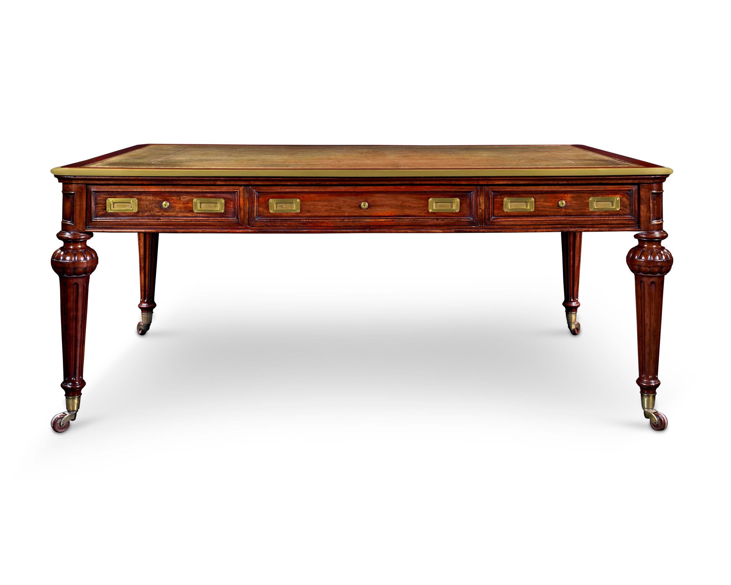This handsome library table is a remarkable example of the English furnishings that represented wealthy Victorian tastes. The piece is attributed to Holland & Sons, a firm regarded as one of the most important cabinetmakers of the era. Crafted of