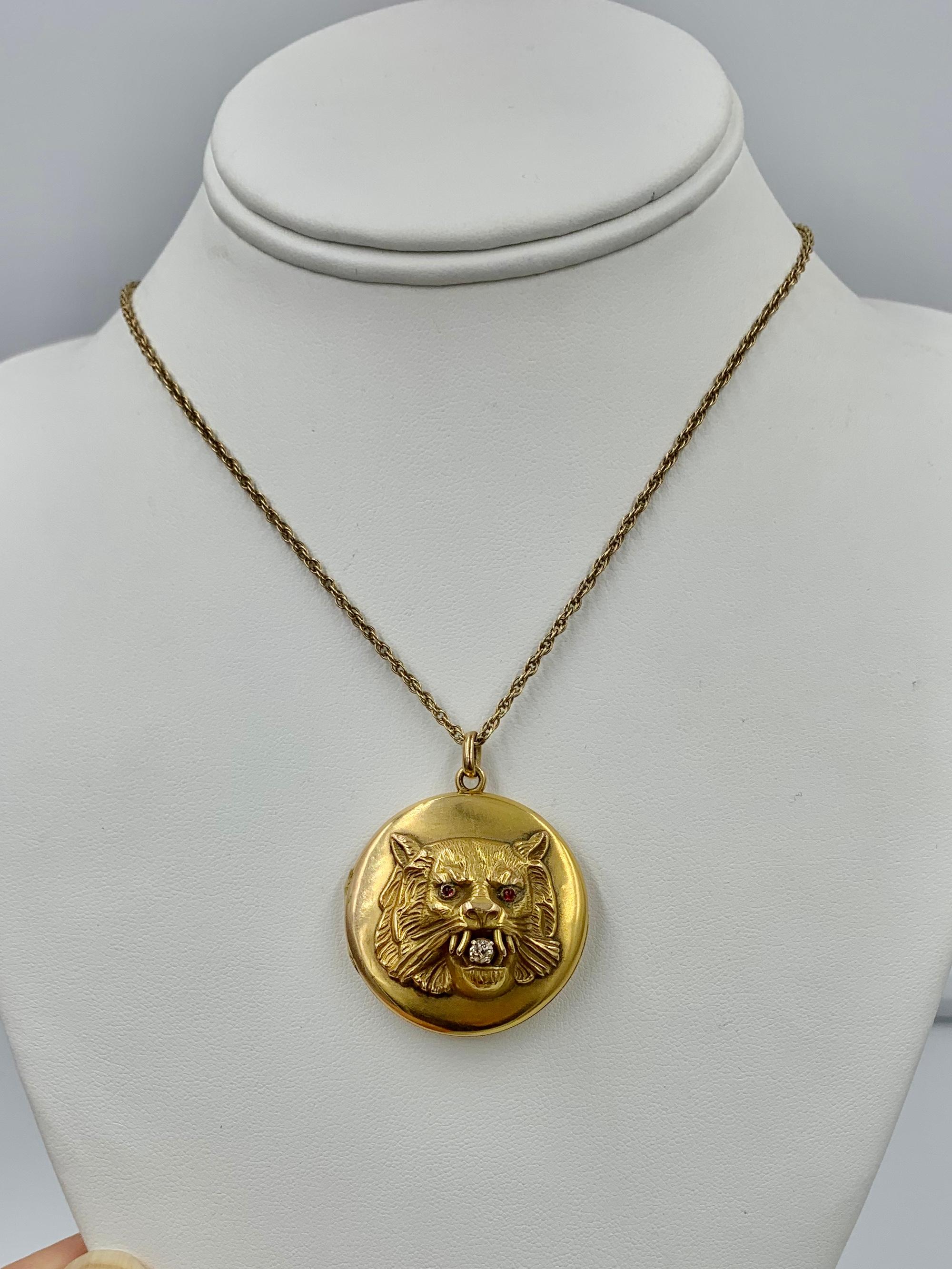 A spectacular antique Victorian lion, panther, leopard or tiger locket and chain in 14 Karat Gold with an Old Mine Cut Diamond in the mouth and Ruby cabochons in the eyes, in an extraordinary three-dimensional design.  One of the most spectacular