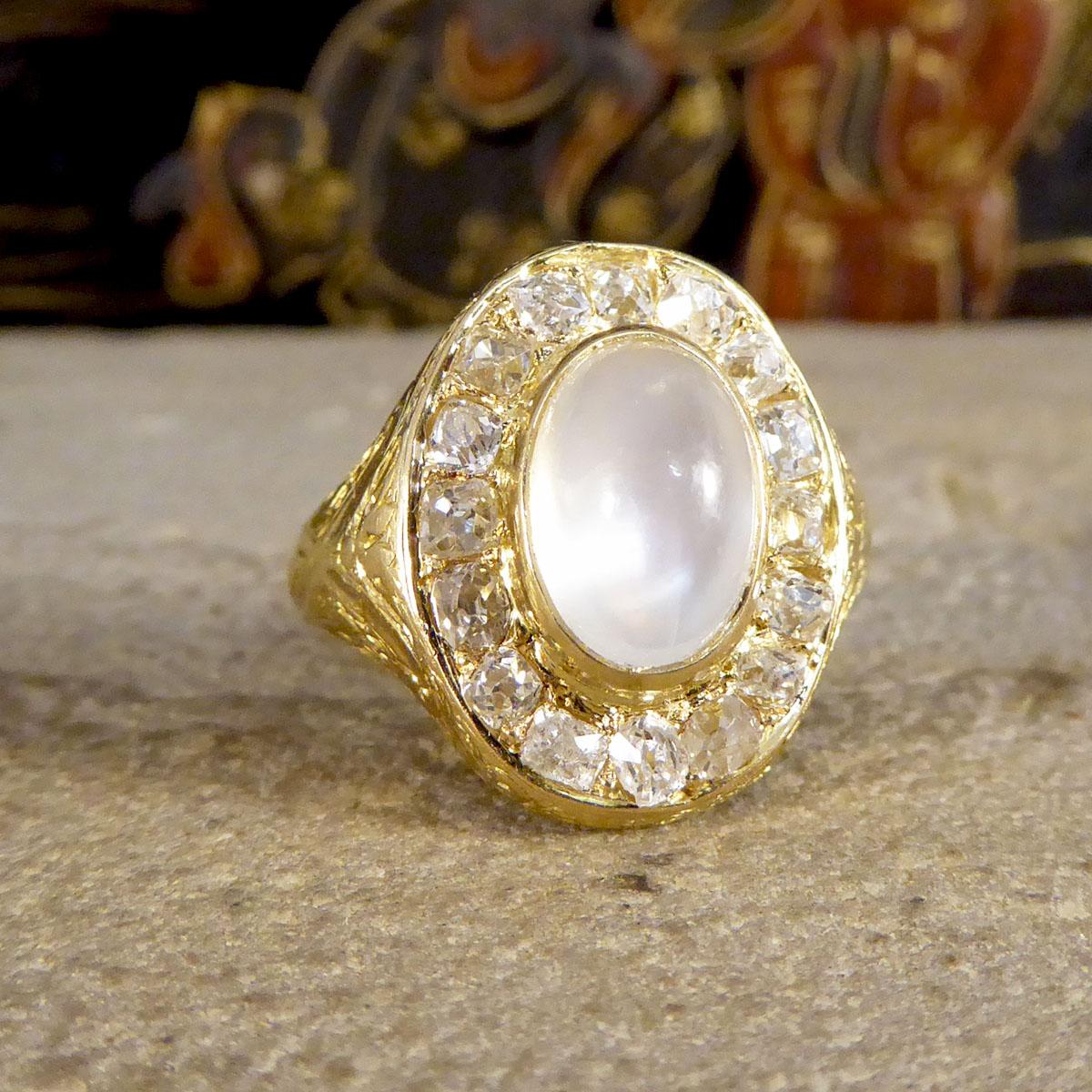 An absolutely stunning and unusual locket backed antique ring hand crafted in the Victorian era. This ring features a Moonstone centre surrounded by approx 1.44ct Old Cut Chunky Diamonds all in slightly different shapes in claw settings leasing down