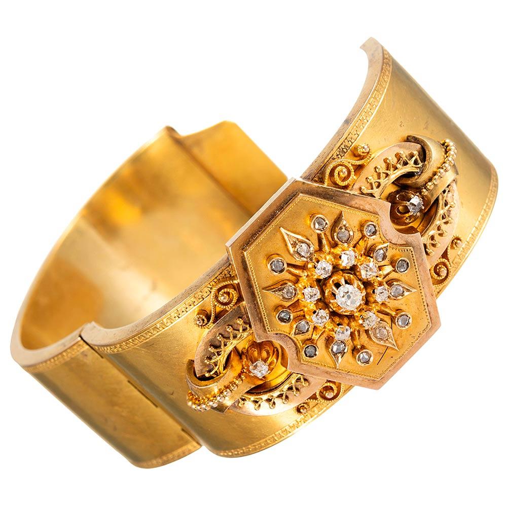 This beautifully designed antique cuff has striking presence on the wrist. The scrolling centerpiece is ornately appointed with eleven old European cut diamonds that weigh .60 carats, as well as additional rose cut diamonds. Concealed behind the