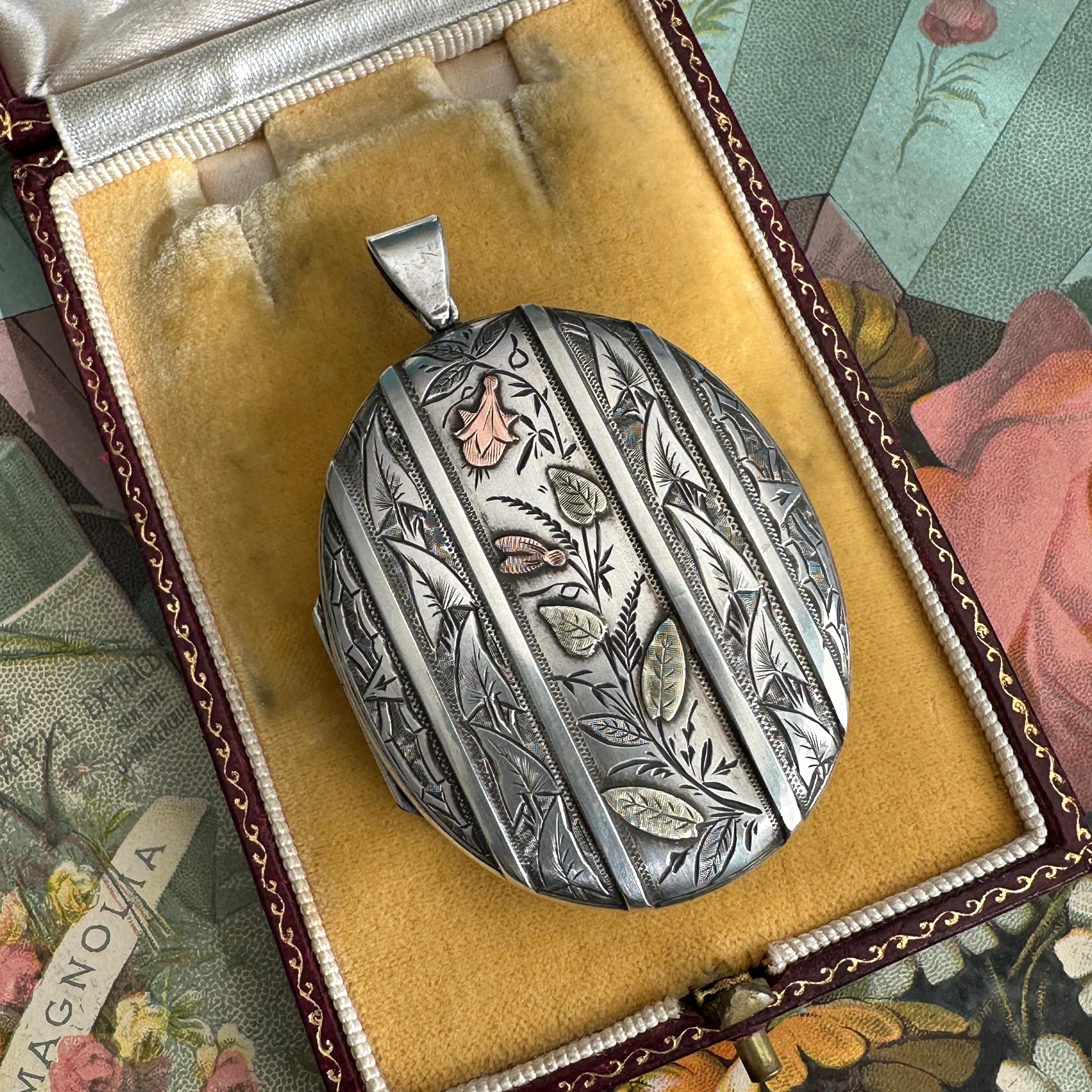 Locket ONLY. Does NOT include chain. 

Details:
Victorian European Aesthetic movement locket, dating between 1860-1880's. Sweet, romantic Victorian botanical themed sterling silver, yellow and rose gold locket pendant. There are sweet leaves, flower