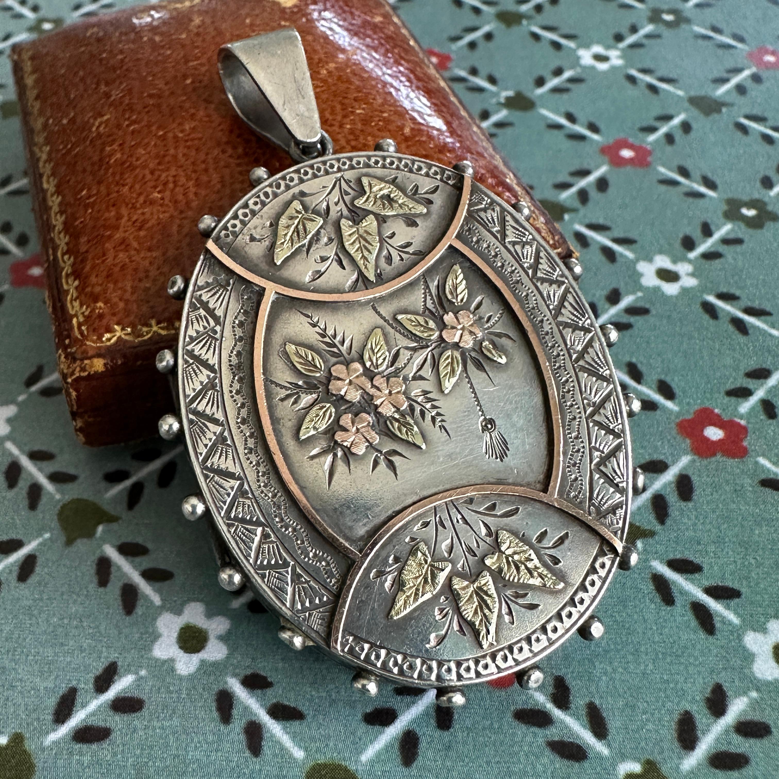 Locket ONLY. Does NOT include chain. 

Details:
Victorian European Aesthetic movement locket, dating between 1860-1880's. Sweet, romantic Victorian floral themed sterling silver, yellow and rose gold locket pendant. There are sweet flowers, and