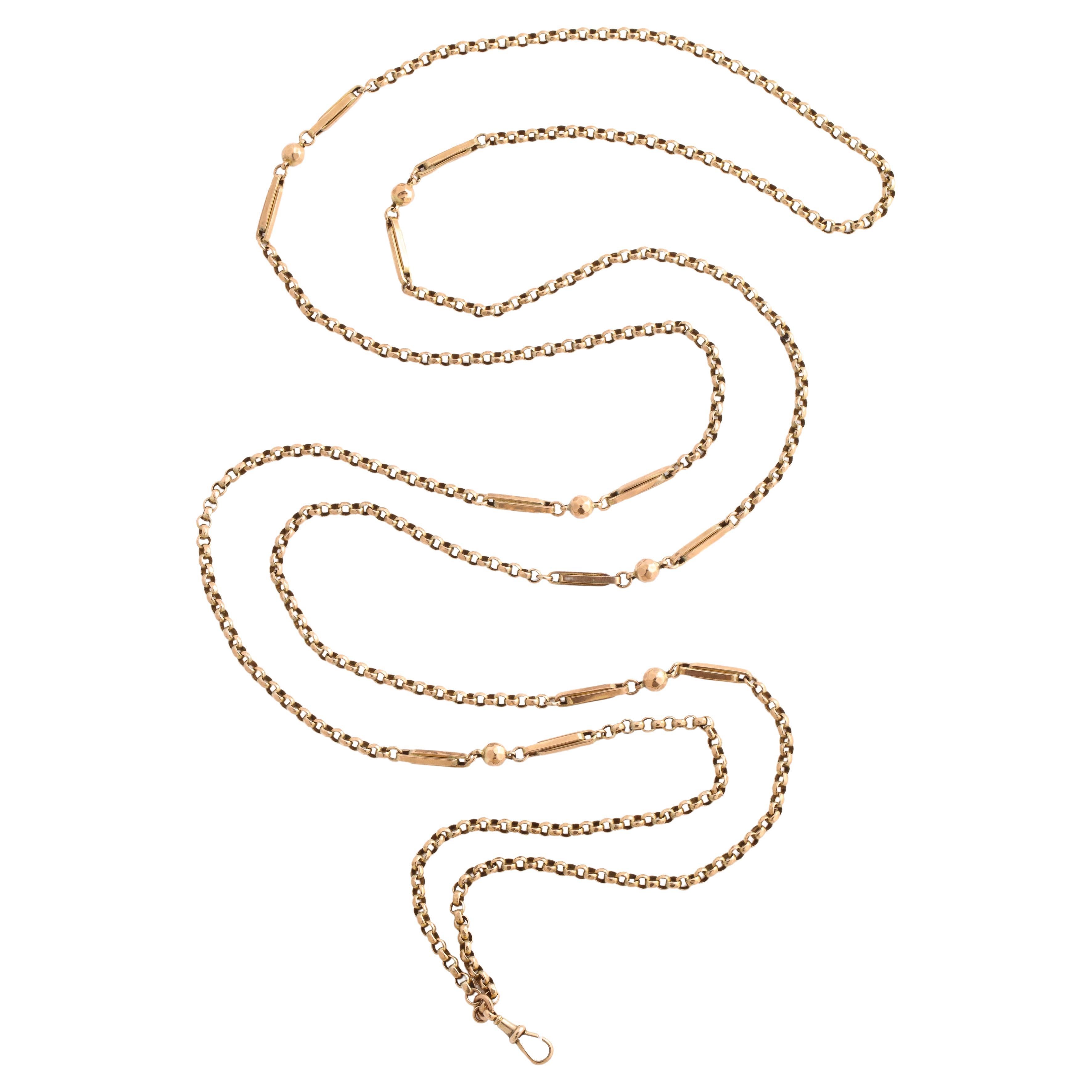 A 32.5 gram Victorian 15 Kt gold long guard chain with beveled beads, tubular links and round links that alternate horizontally and vertically. The chain is greater in texture than are plain chains because of the variety of links. At a grand 60