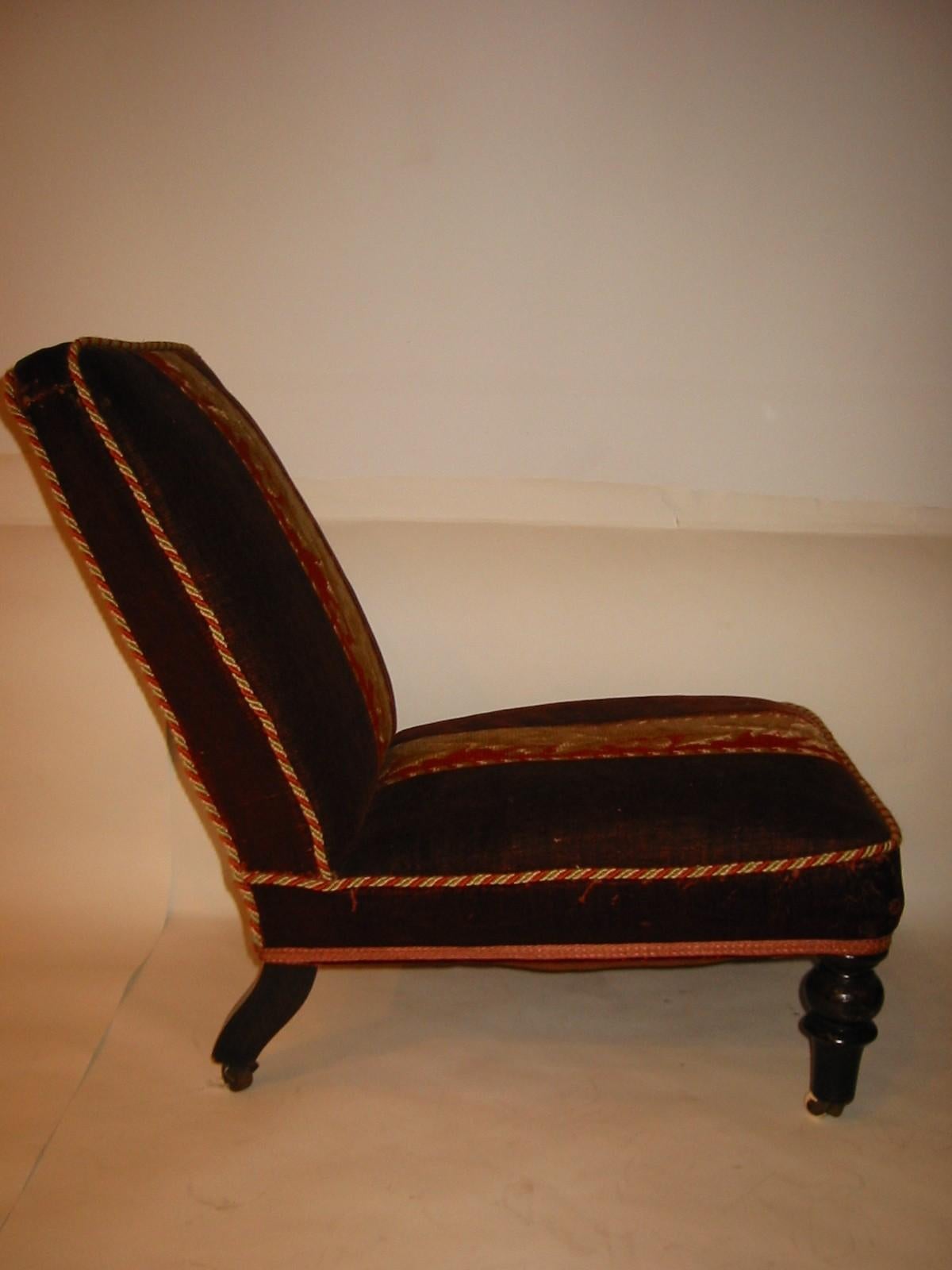 A small Victorian low back reclining chair. Upholstered in original velvet with a needle point accent in the middle.

Property from esteemed interior designer Juan Montoya. Juan Montoya is one of the most acclaimed and prolific interior designers