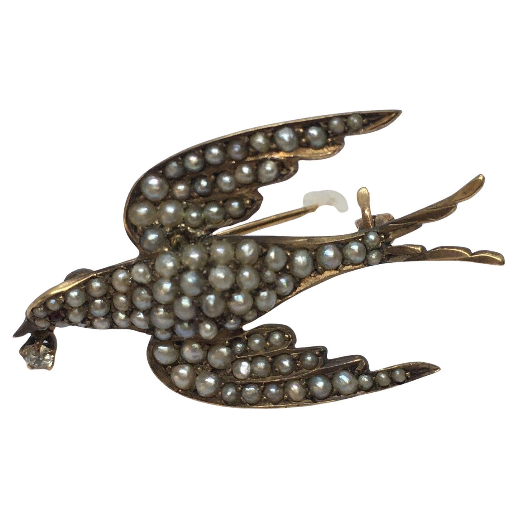 Victorian Low Karat Gold Brooch Swallow in Flight Seed Pearls Ruby Diamond 1880s For Sale