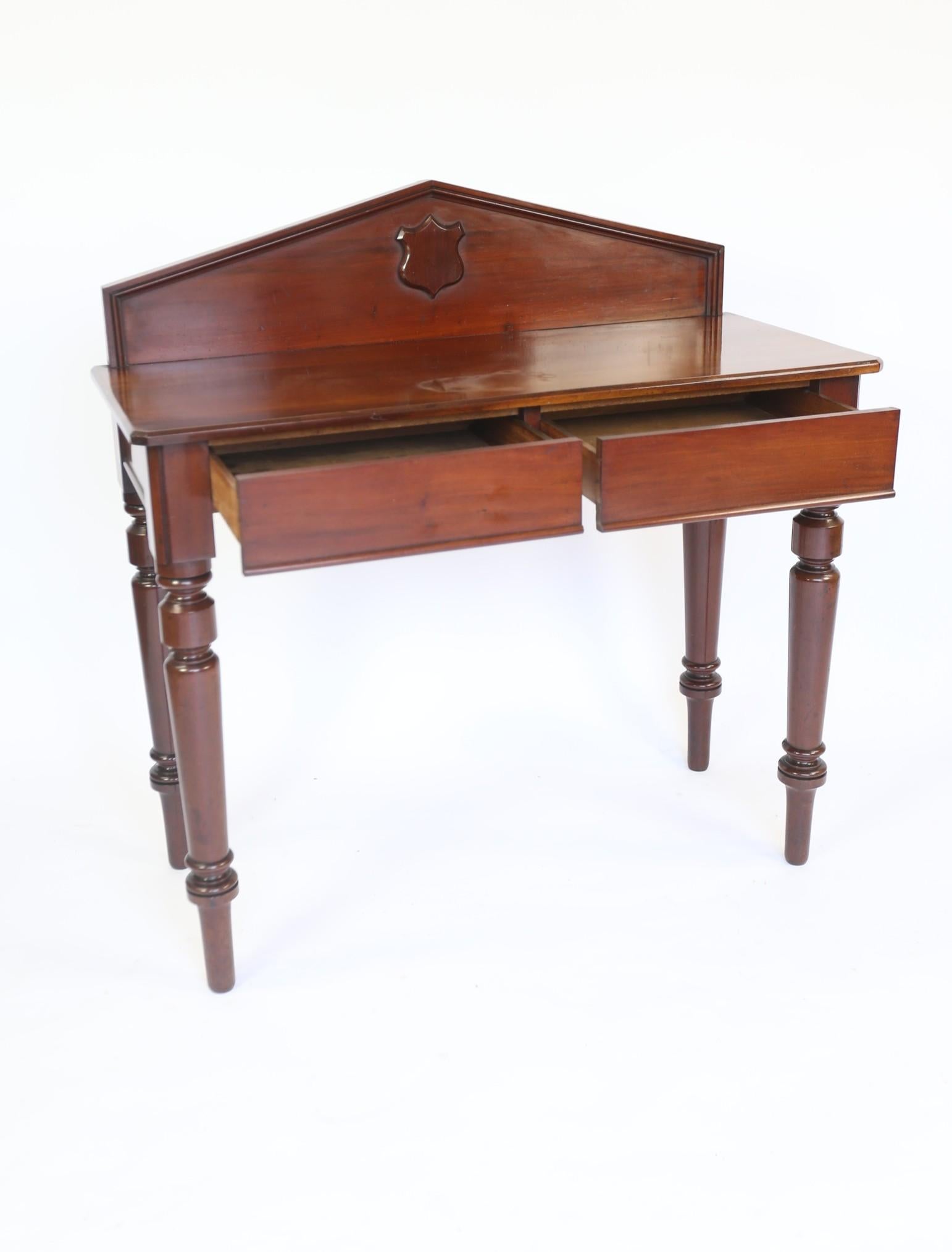 Victorian Mahogany 2 drawer Hall/ Serving Table
Mahogany Upstand Back with carved Shield in Centre, 
Mahogany Top With Thumb mould edge, 
Pair Frieze  Drawers with Mahogany Linings, 
Sitting on 4 Turned & Tapered Legs
Recently Polished
Good Quality