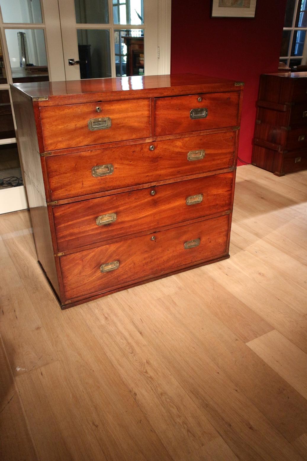 Here is an example of a good quality antique military Campaign mahogany two-part chest of drawers with secretaire.
This Campaign chest would have been commissioned for a member of the British Raj or a high-ranking officer in the British Army during