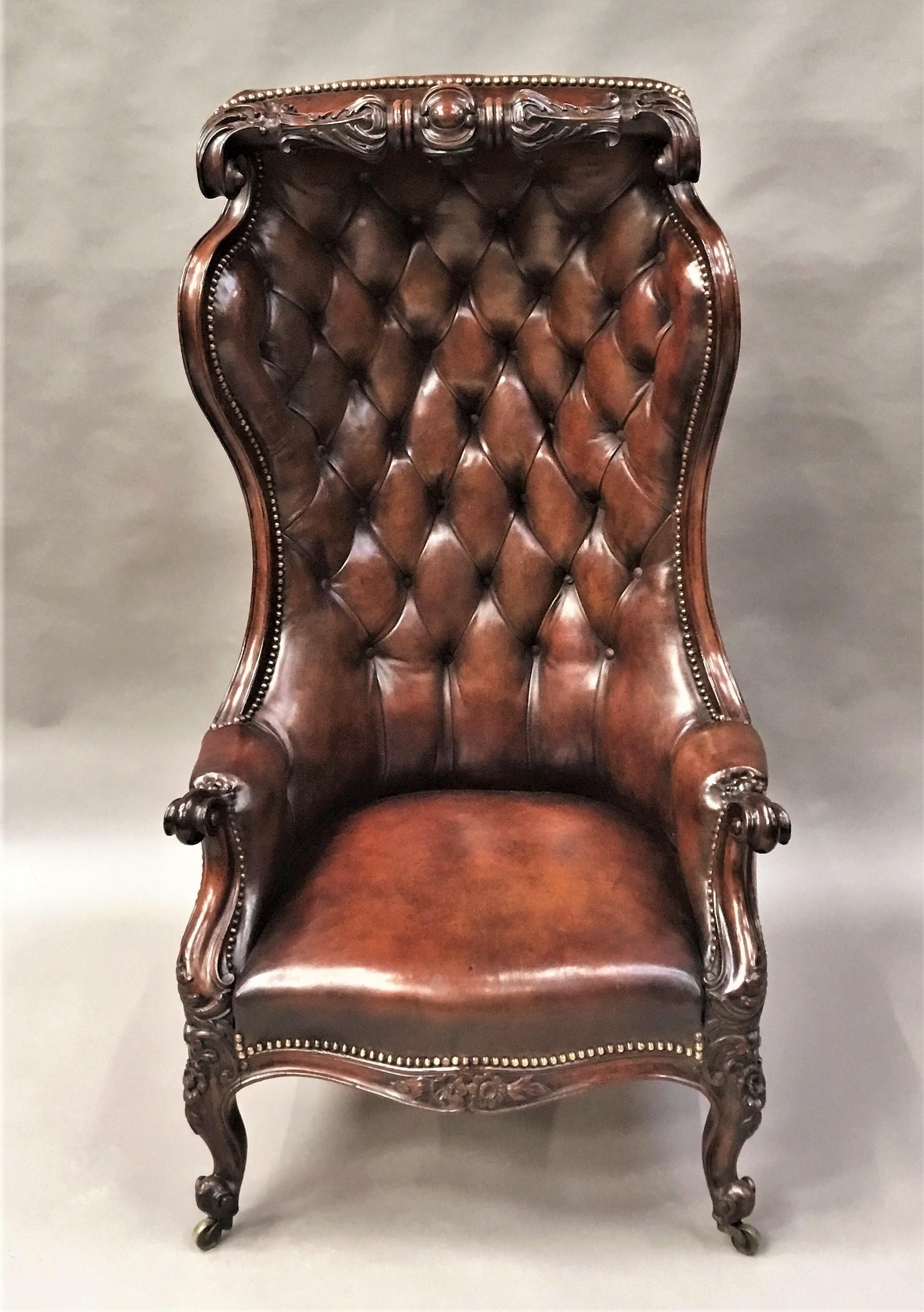 Spectacular Victorian mahogany and leather hall porters chair / hooded wing chair of very unusual form; the bold carved mahogany crest rail with acanthus carving and scrolled ends above the shaped back with scrolled wings upholstered in buttoned