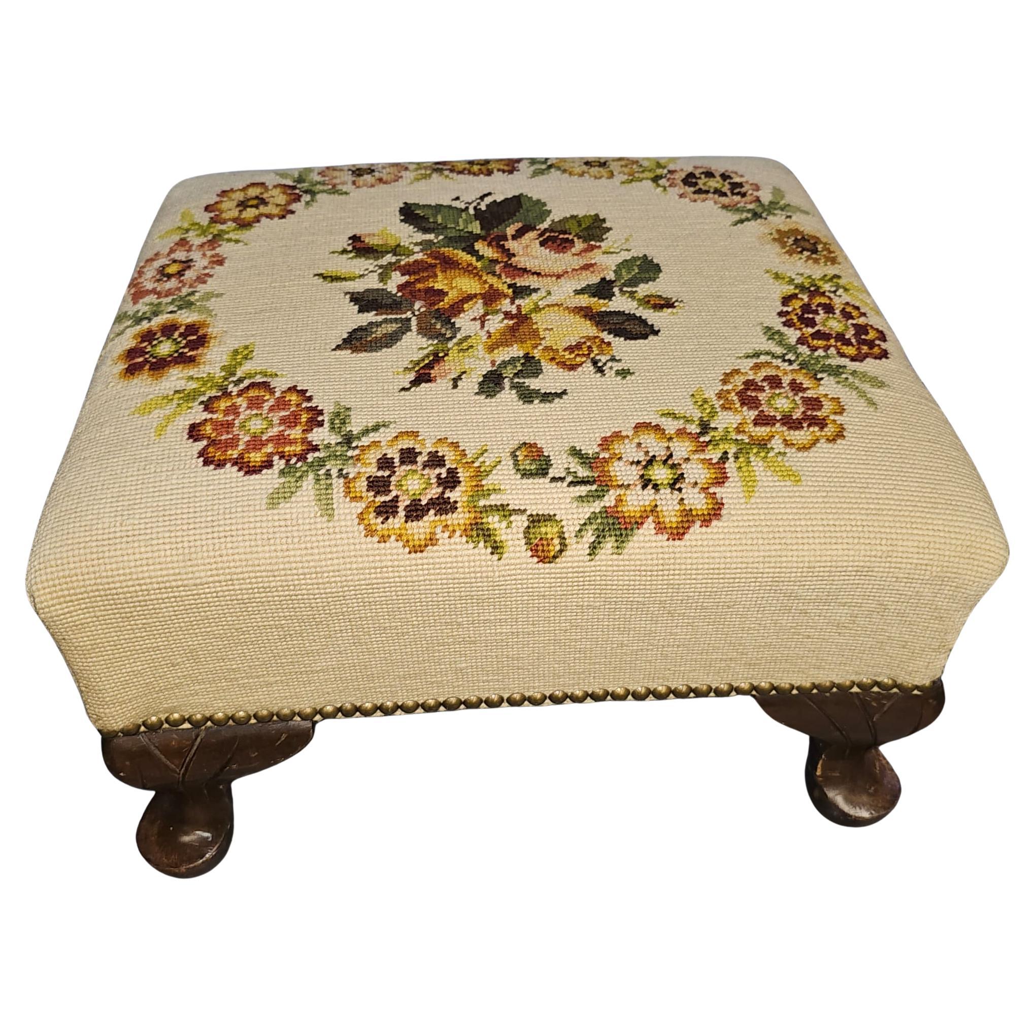 A Victorian Mahogany and light yellow Needlepoint Upholstered Footstool with brass nail studded.
Measures 16.5