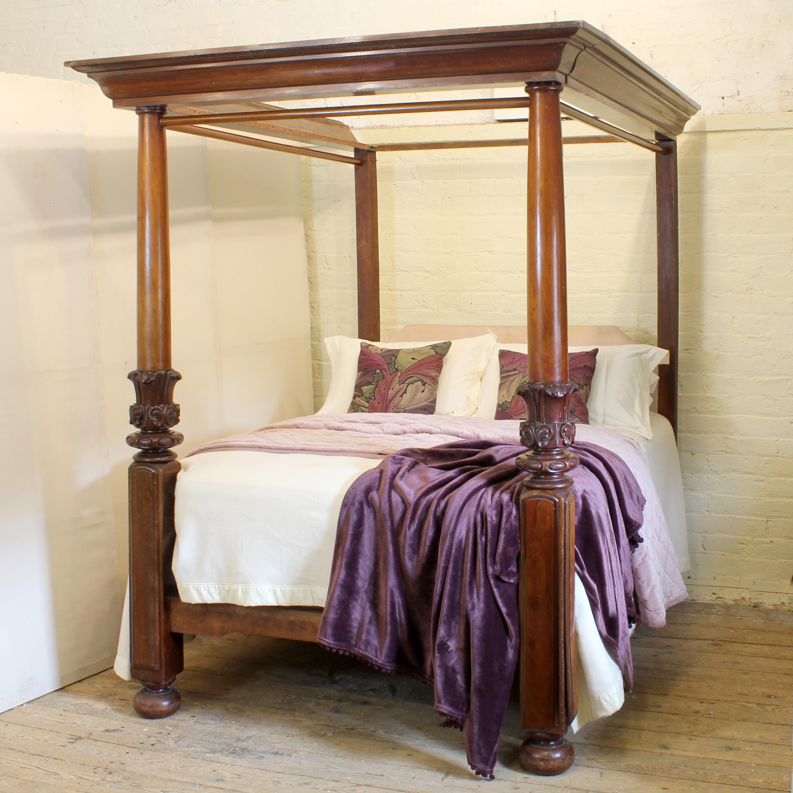 A superb Victorian mahogany four poster bed from the mid Nineteenth Century. The substantial mahogany front posts have bun feet, square section plinths with tall, bevelled and arched cover plates, large bulbous central features of acanthus leaves,