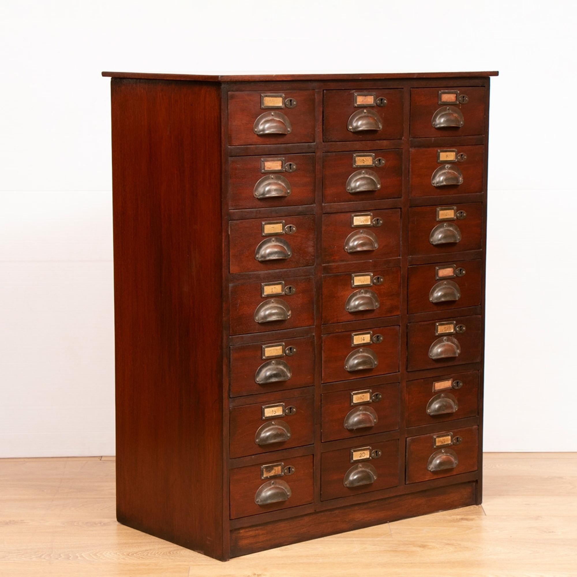 An antique bank of 21 drawers in mahogany with metal cup handles and label holders.
This is the Classic late Victorian era front of counter Shop fitting or Haberdashery fitment you would find all-over England in every village and town up and down