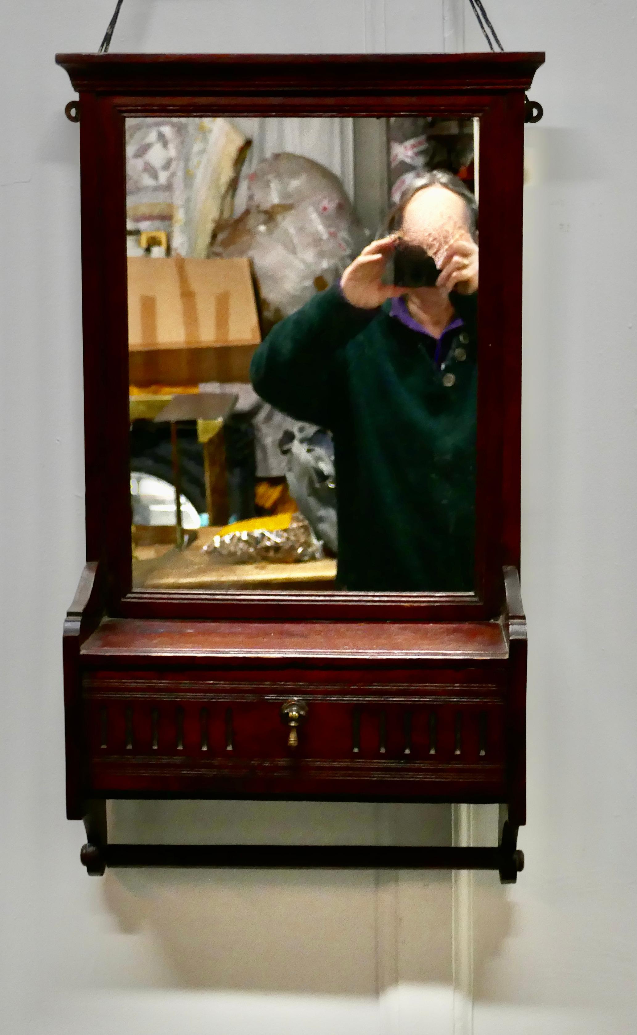 Victorian mahogany bathroom wall mirror with towel rail

This is a very attractive piece, which would work very well in a bathroom or cloak room
The mirror has a small shelf beneath this there is a fall which accesses a small storage box, below
