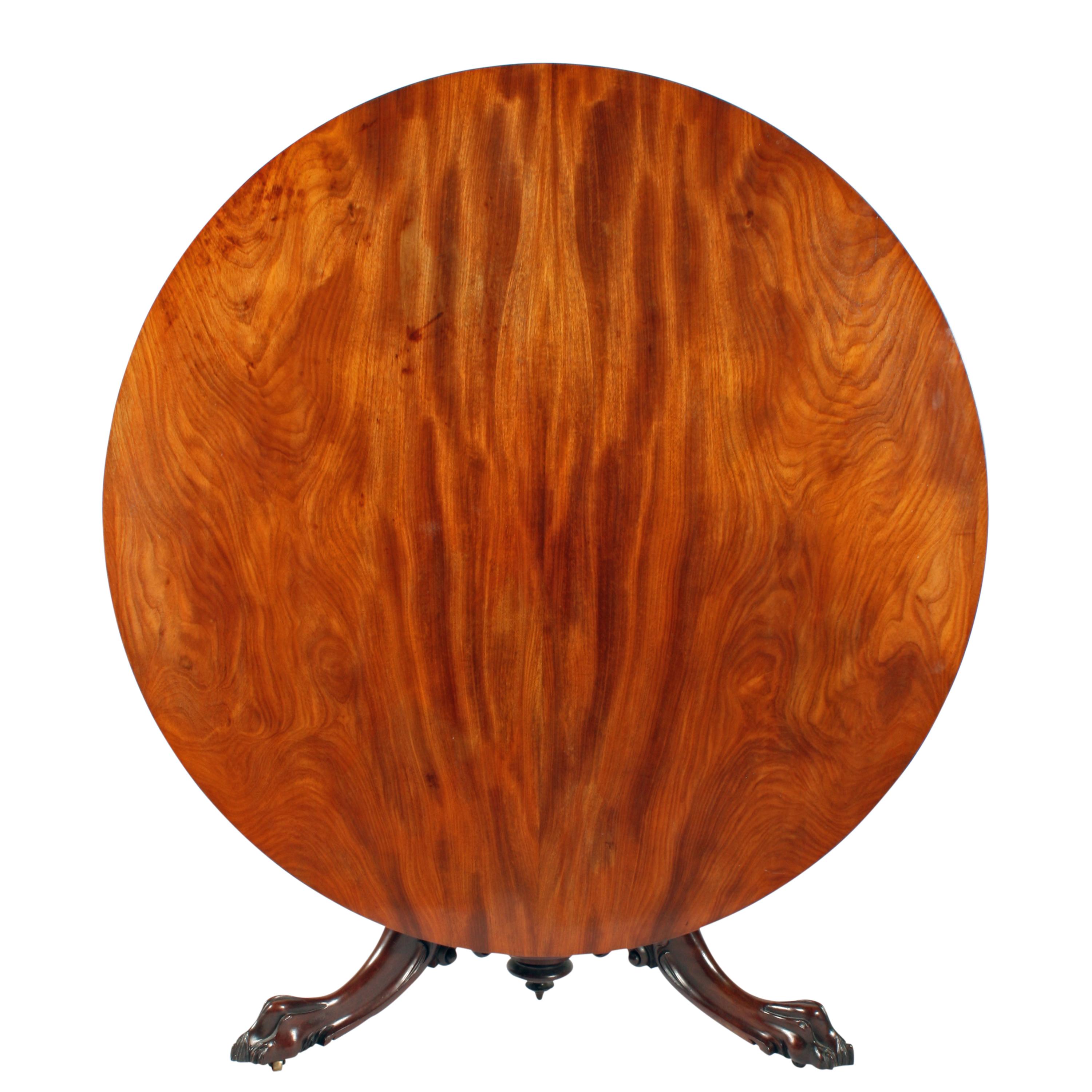 A middle of the 19th century Victorian breakfast or centre table.

The table has a circular figured mahogany veneered top with a square edge sitting on a tripod base.

The base has three cabriole legs with carved claw feet, carved scroll