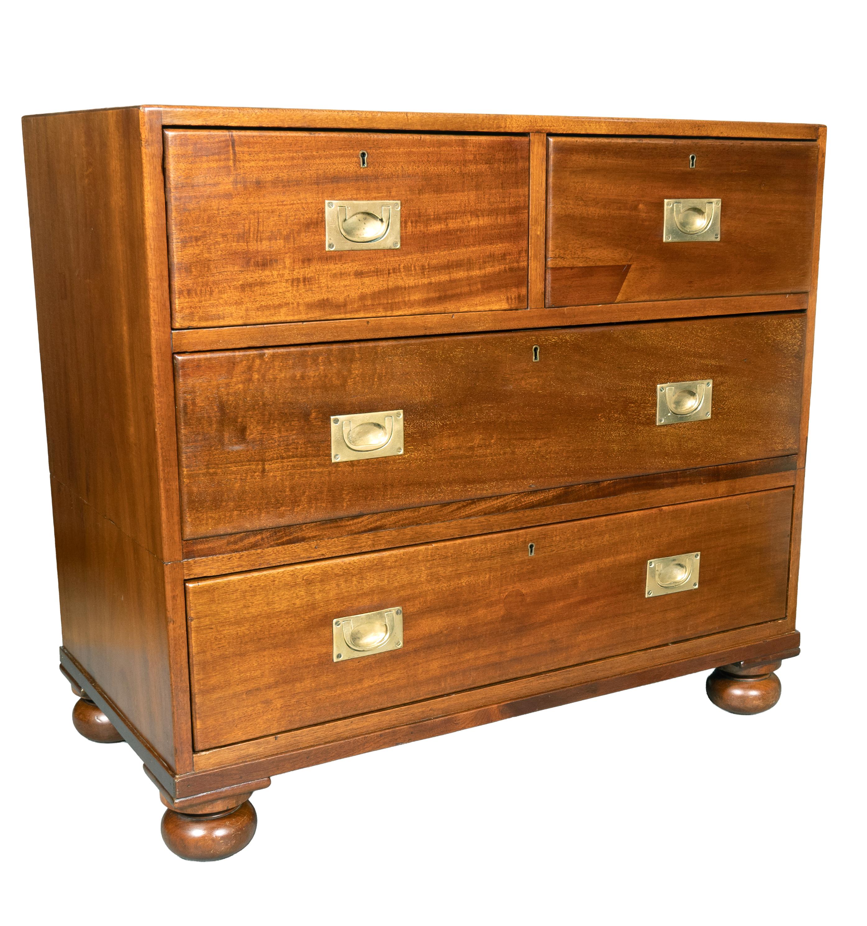 Altered and originally in two parts. Seems that drawers were reduced to make it a lower chest. Two short drawers over two long drawers with inset brass handles. Bun feet.