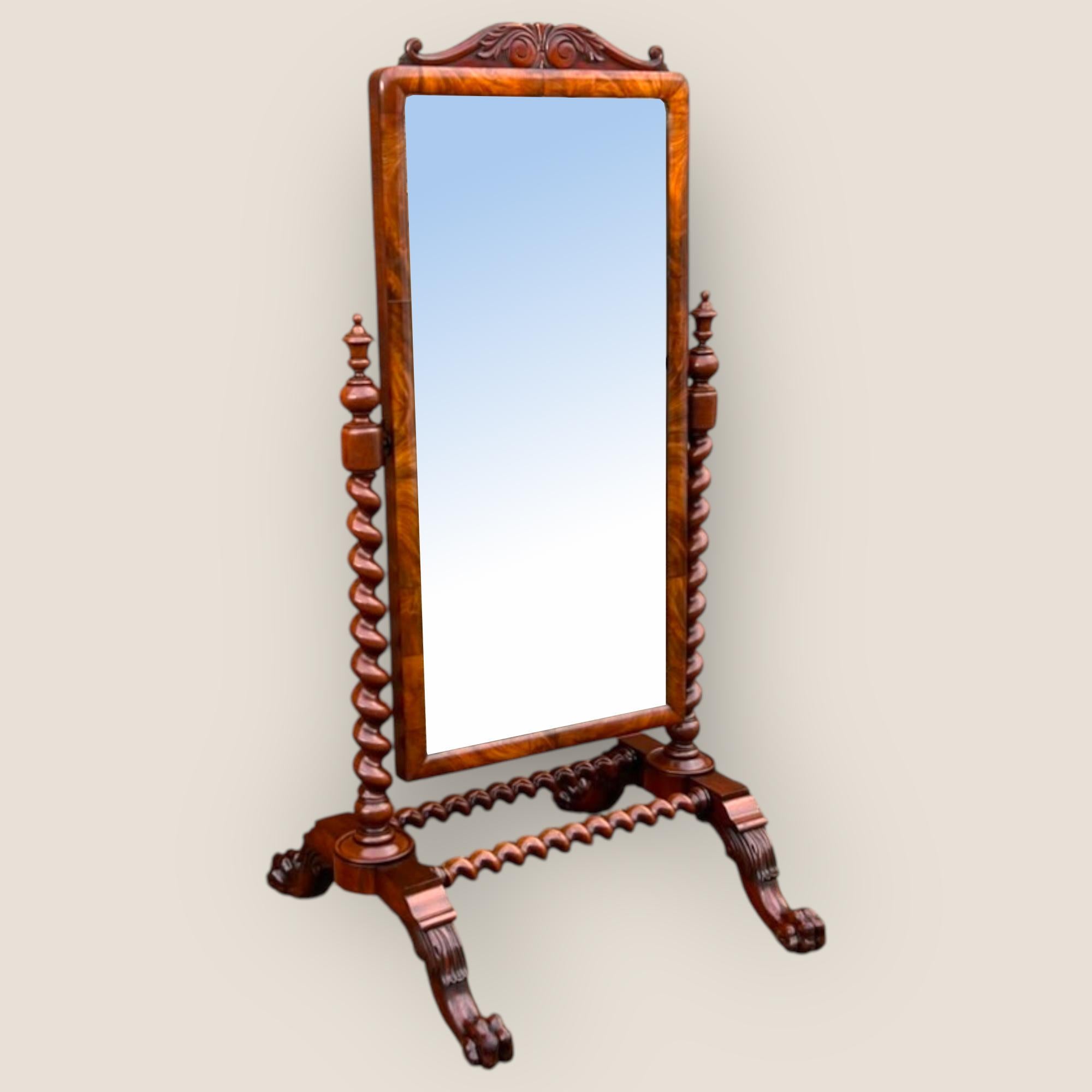 A Large Early Victorian Mahogany Cheval Mirror with barley twists columns and supports, standing proud on impressive lion feet with casters. A scroll pediment to the top and further scroll detailing between the legs. The brass screw mechanisms which