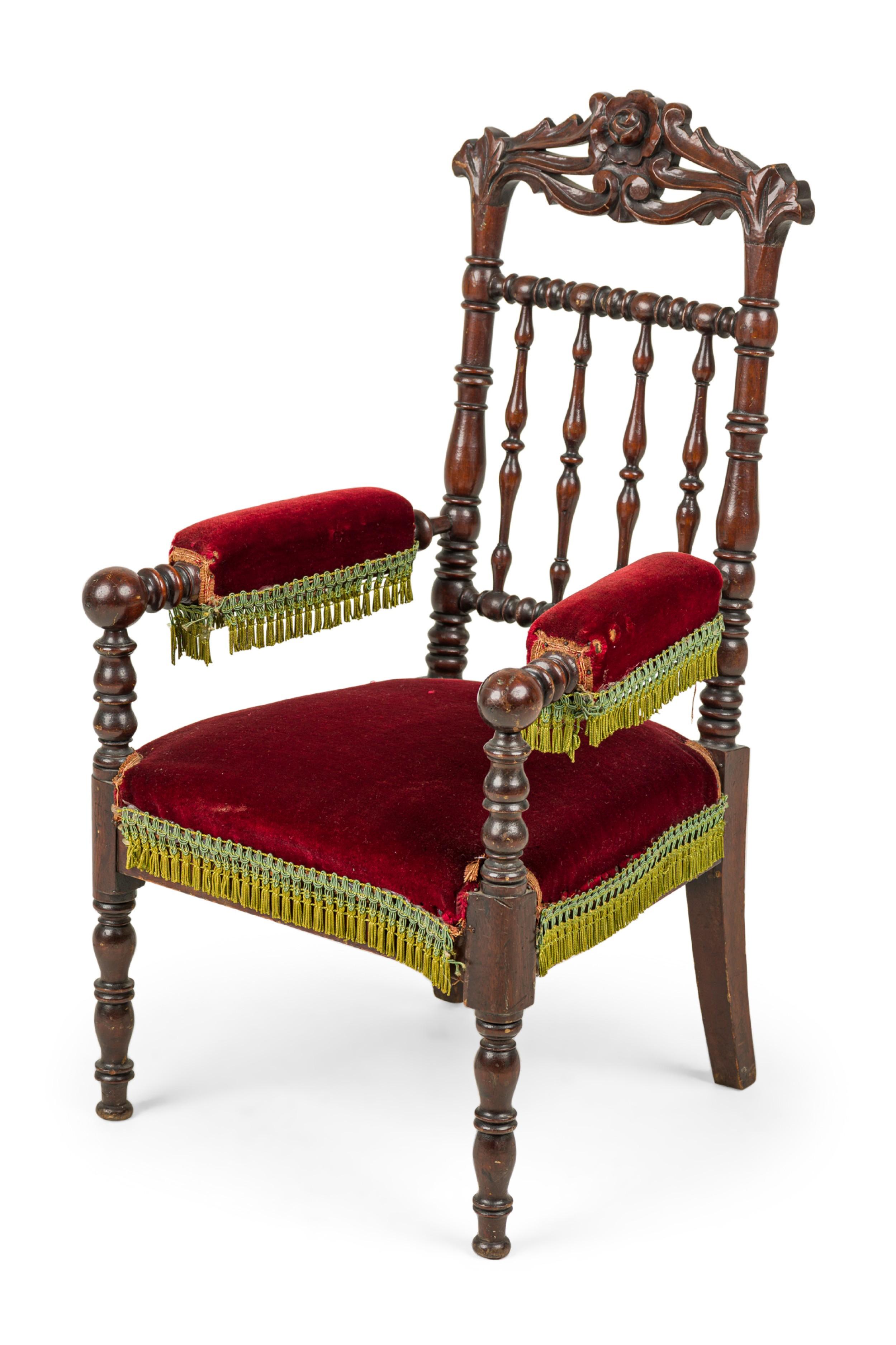 English Victorian mahogany spindle back child's arm chair with red velvet seat.