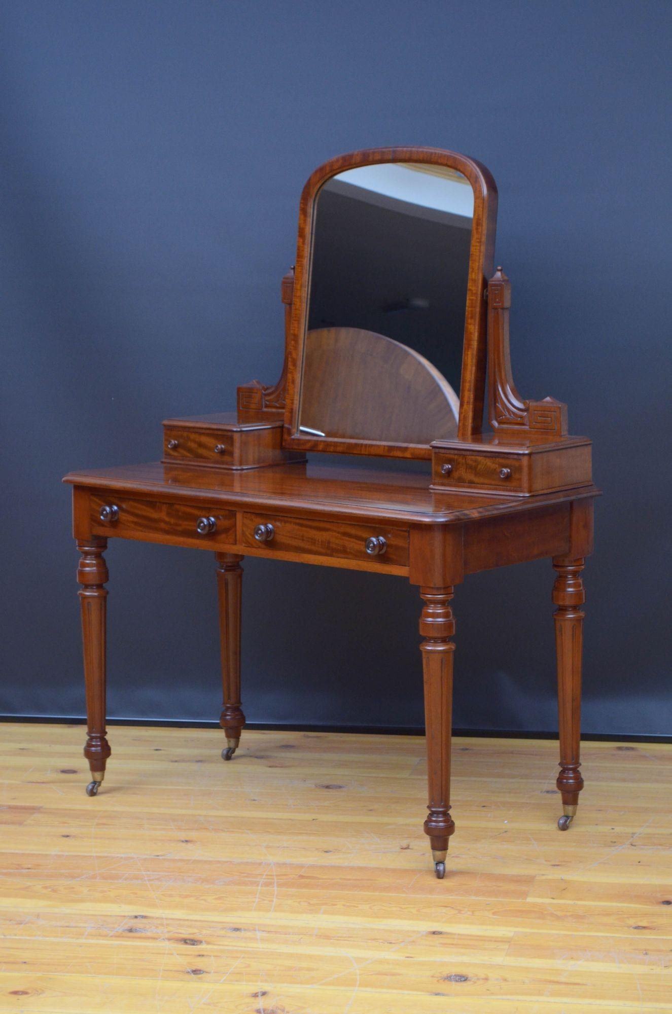 St033 Fine quality English Victorian dressing table in mahogany, having arched mirror with replacement glass, in carved supports with Greek key decoration terminating in small jewellery drawers and figured mahogany top with moulded edge and two