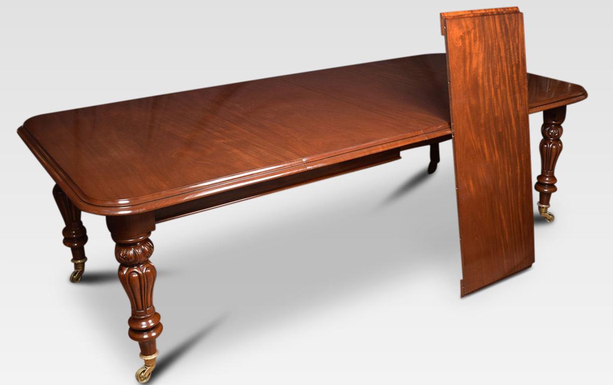 Victorian mahogany extending dining table, the rectangular top with rounded corners and moulded edge, the pull-out action secured by brass clips opening to incorporate two leaves and one half leaf, on turned tapering foliated legs with brass