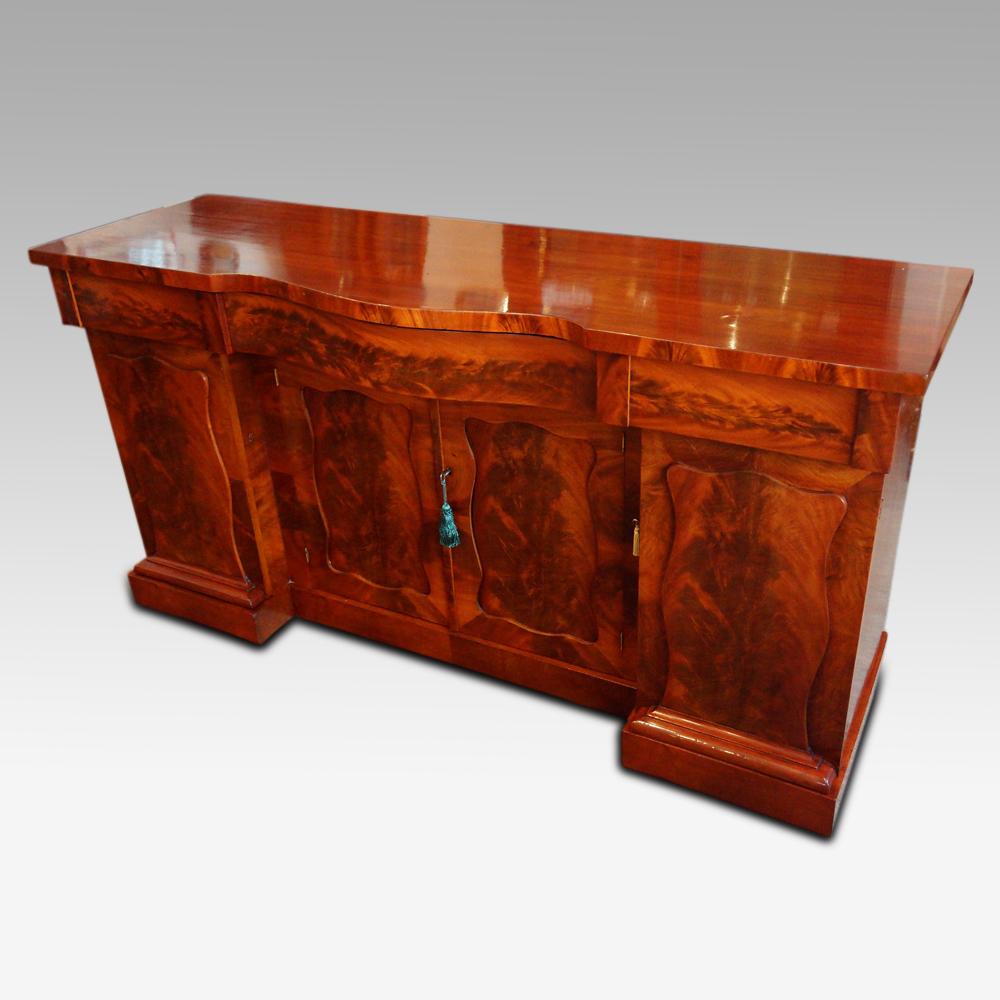 Victorian mahogany four door sideboard 
This Victorian mahogany four door sideboard was made, circa 1865 using dramatic flame veneers.
This sideboard is fitted four cupboard doors (hence the description name). To the left hand side, the single
