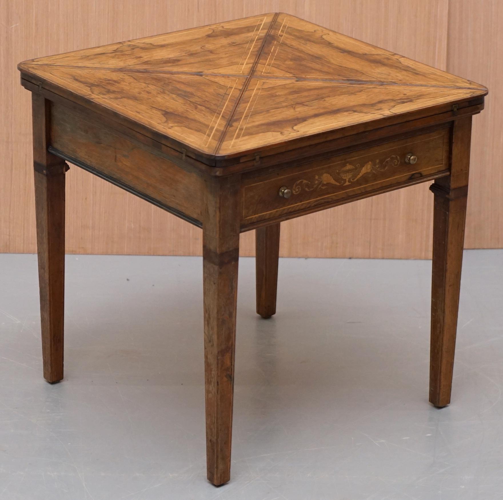 We are delighted to offer for sale this stunning and circa 1880 Victorian English rosewood games table 

A very well made Victorian table, its in rosewood with a baise lining on the inside. I've not seen one in rosewood before, the timber has a