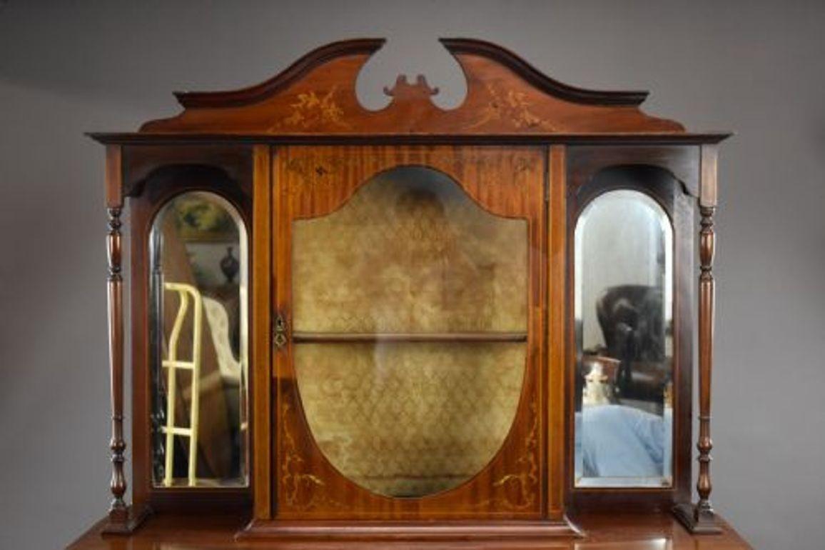 Victorian Mahogany Inlaid Display Cabinet
Circa 1890
An elegant late Victorian mahogany inlaid display cabinet of refined proportions. The upper section features a shaped pediment with decorative marquetry inlay, flanked by mirrored side panels and