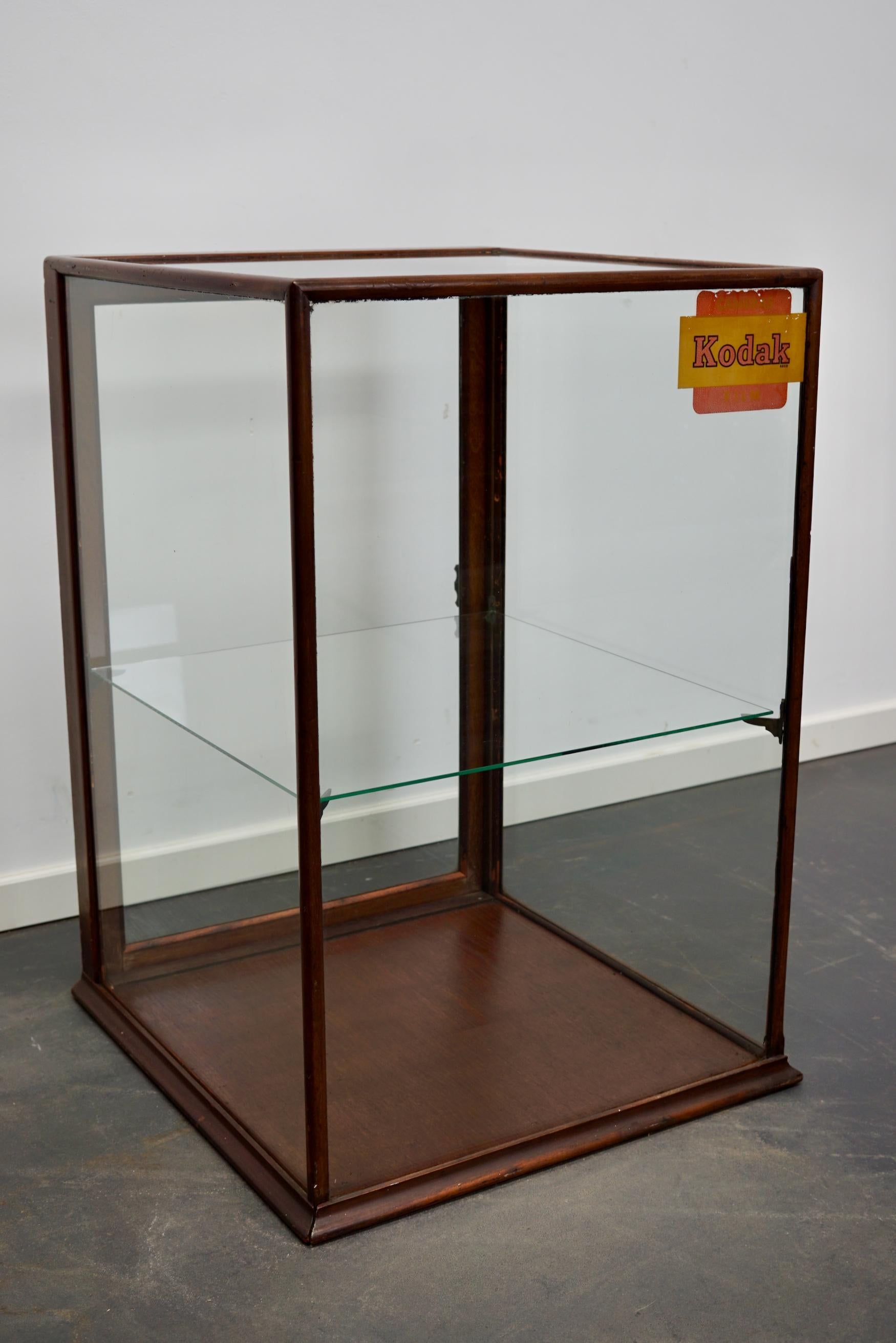 A museum quality Victorian mahogany display cabinet. This outstanding cabinet has a glass door fitted with the original knob handle. At some point in it's life it was used in a camera store.