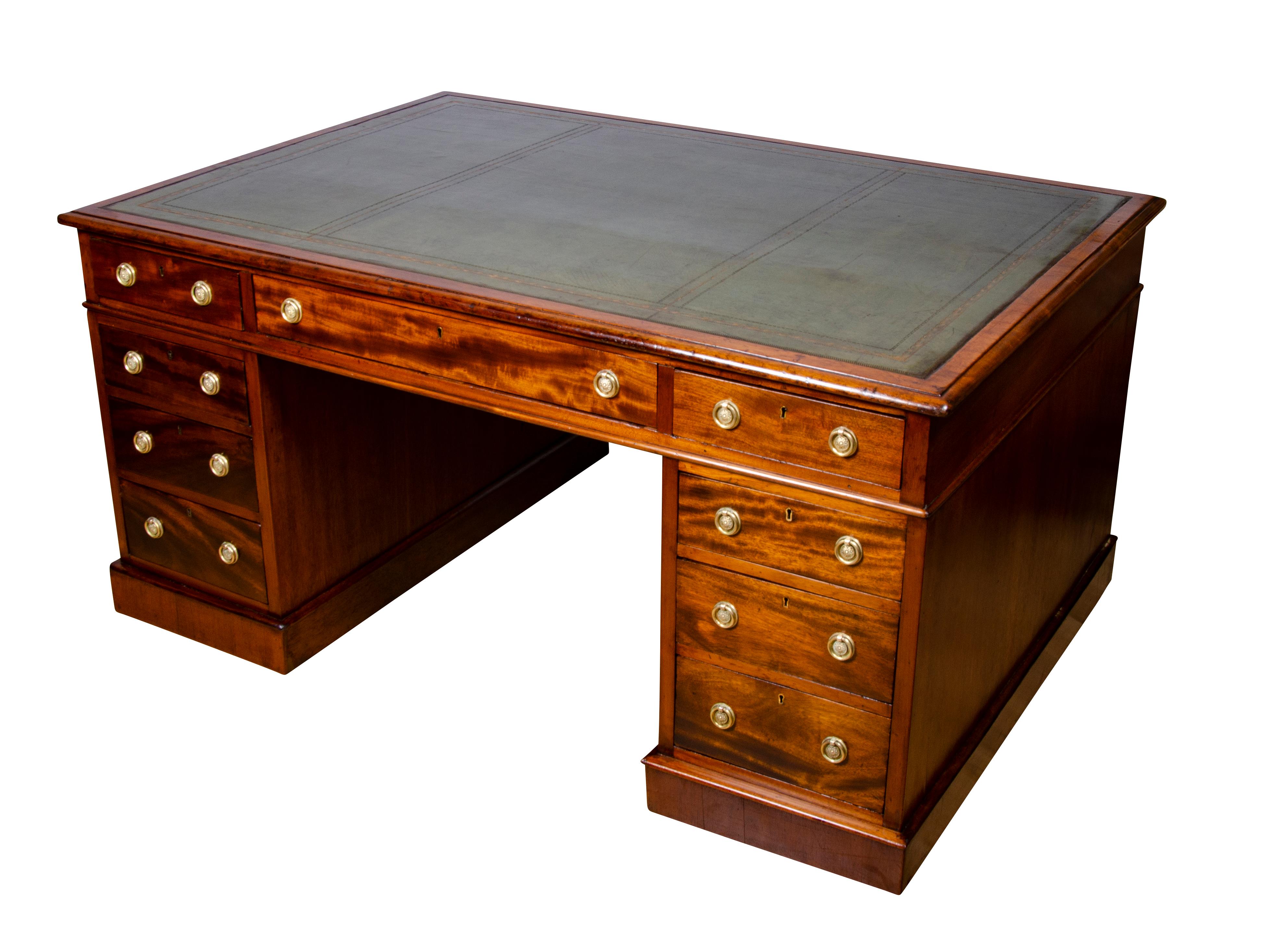 With a rectangular top with inset green leather top over three drawers over two pedestals with three drawers each, the back with same drawer configuration. Plinth base.