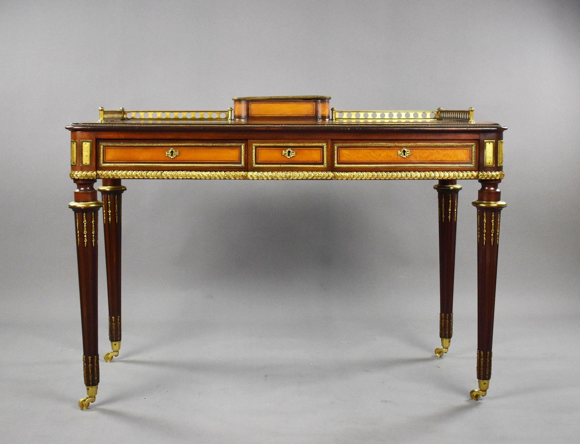 For sale is a top quality mahogany and satinwood writing table stamped Edwards & Roberts. Being constructed from mahogany and fine satinwood the writing table has a writing utensil compartment, with perforated three quarter brass gallery surrounded