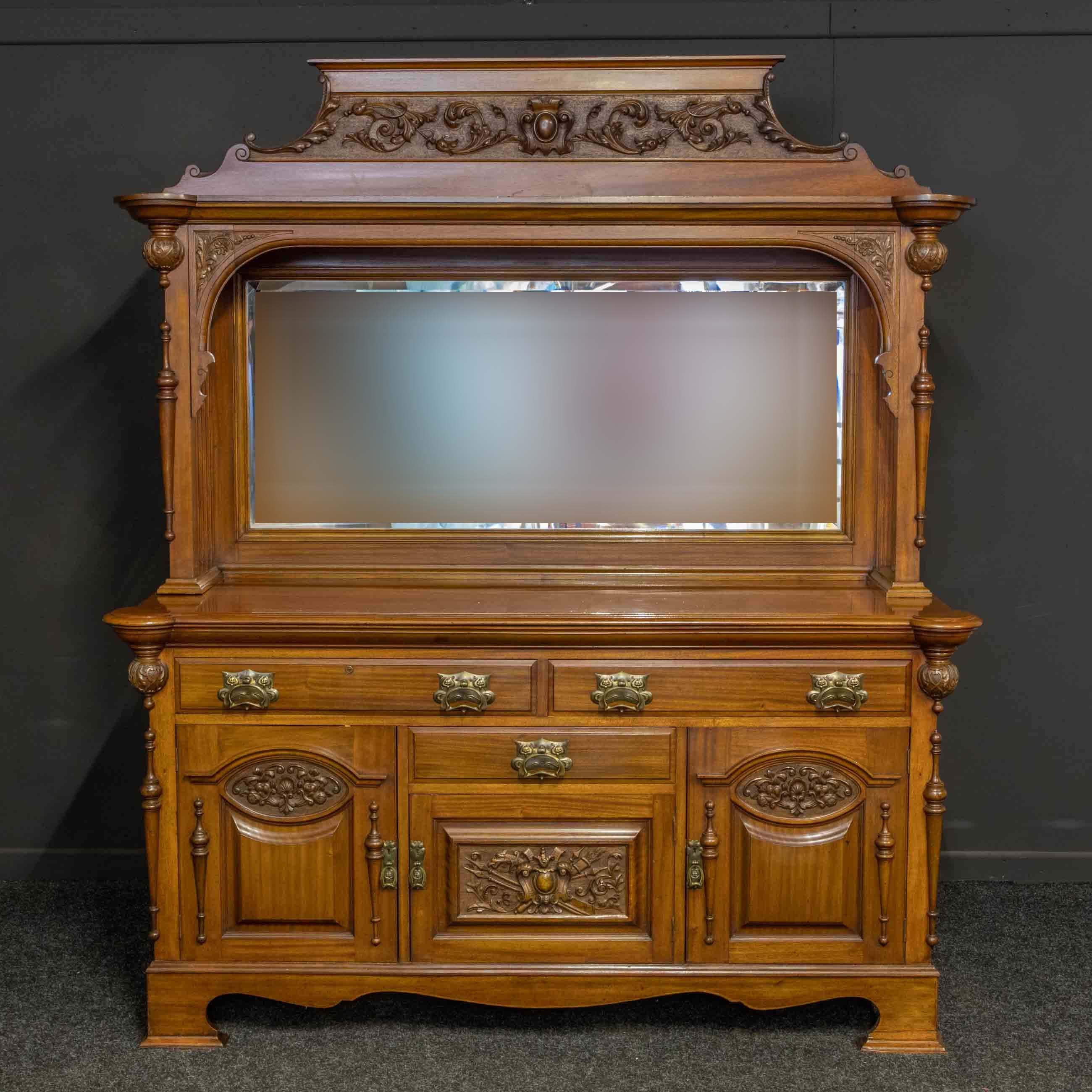 A superb quality Victorian mahogany sideboard from the late 19th century with well carved decoration to the doors and pediment. An unusual feature of this piece is the 3/4 split mouldings to the top and bottom edgings, which terminate to more rich