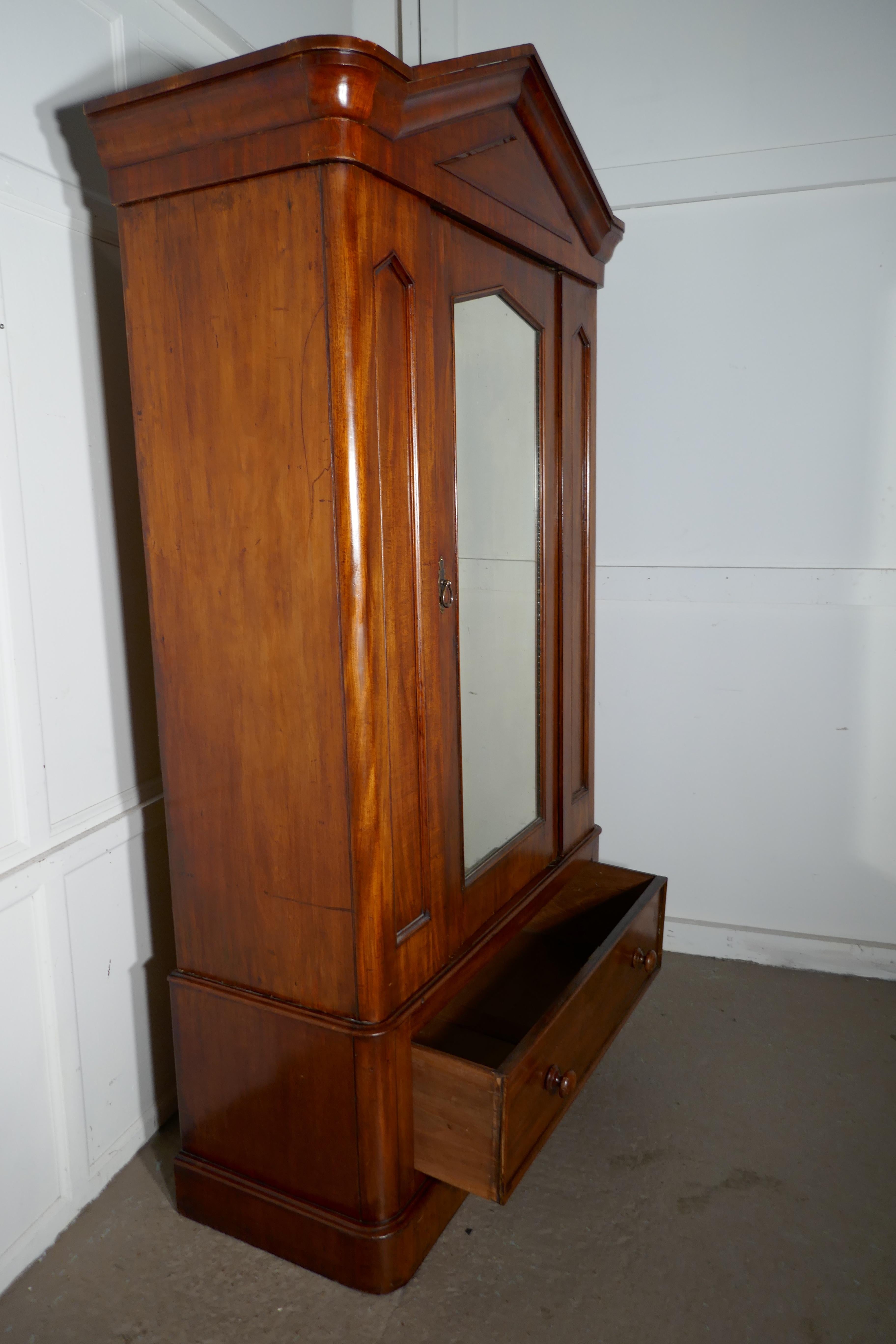 Victorian mahogany single wardrobe 

This is a very attractive piece, the mahogany wardrobe is a good quality piece, it has a mirrored door and a deep pointed pediment

The Interior has a new hanging rail, and there is a deep drawer at the