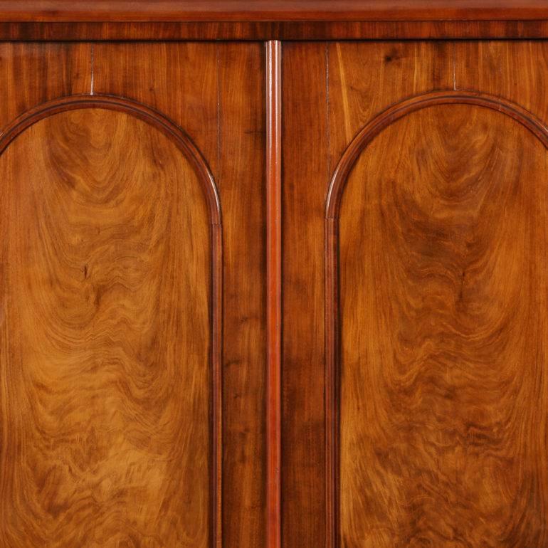 An English Victorian wardrobe with two arched-panelled doors, each with inset book-matched panels. Fitted with upper and lower rods for hanging, but could as easily have shelves, circa 1880.



 