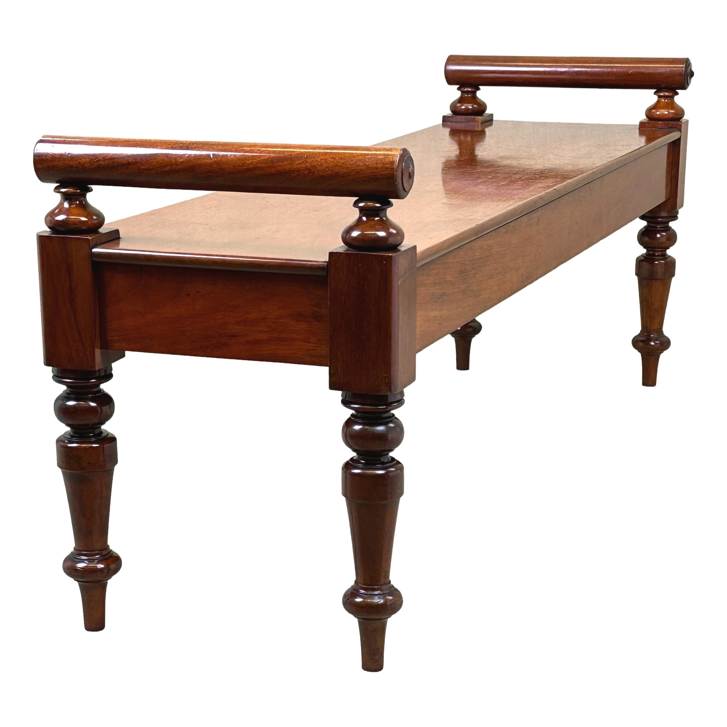 A very good quality, mid 19th century, Victorian Period Mahogany window seat hall bench, of unusually large proportions, having superbly figured rectangular top with elegant raised turned rolls to each end, raised on turned tapering legs.


These